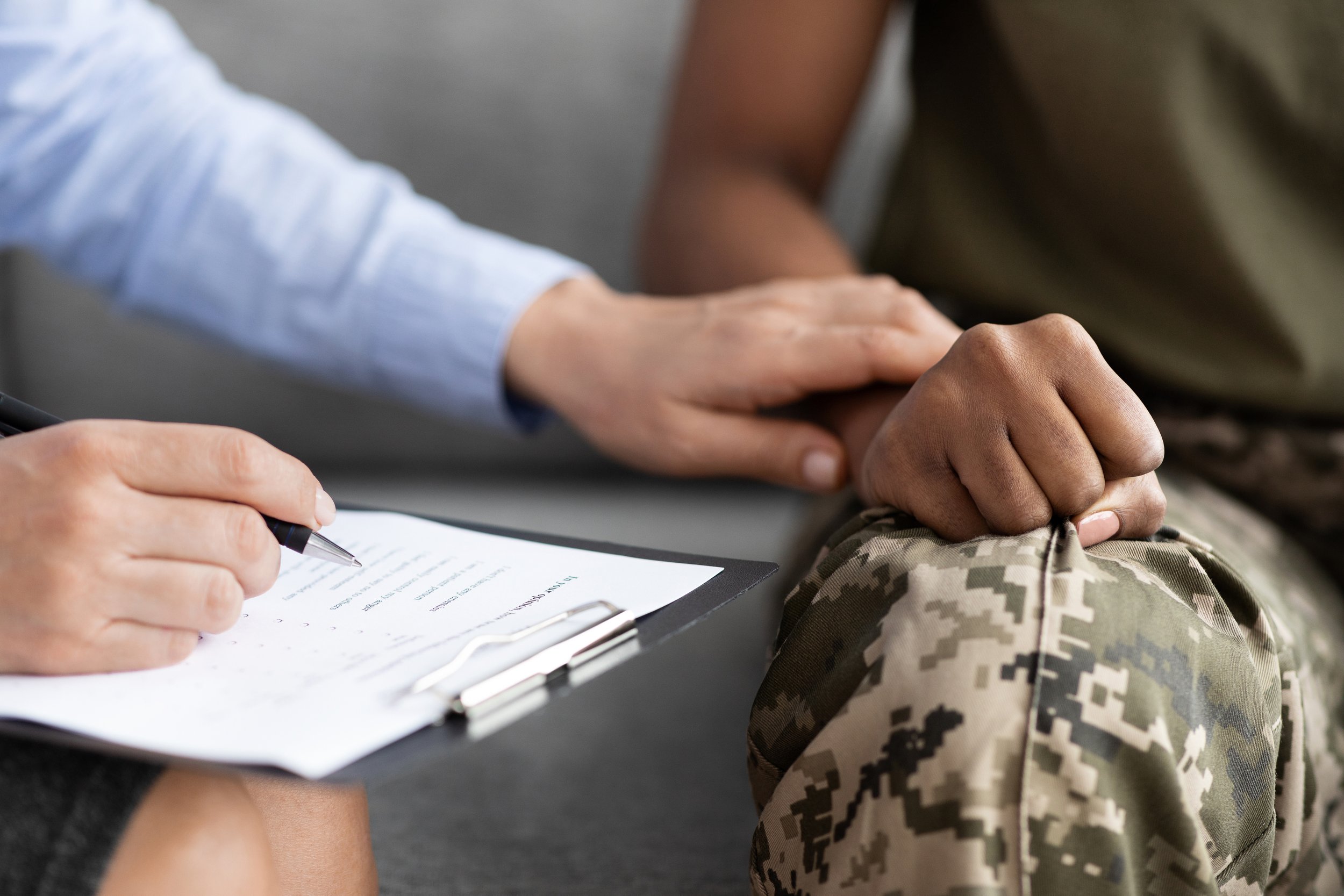 Closeup-Shot-Of-Psychotherapist-Supporting-African-American-Soldier-Woman-During-Therapy-Session-1369014085_3869x2579.jpeg