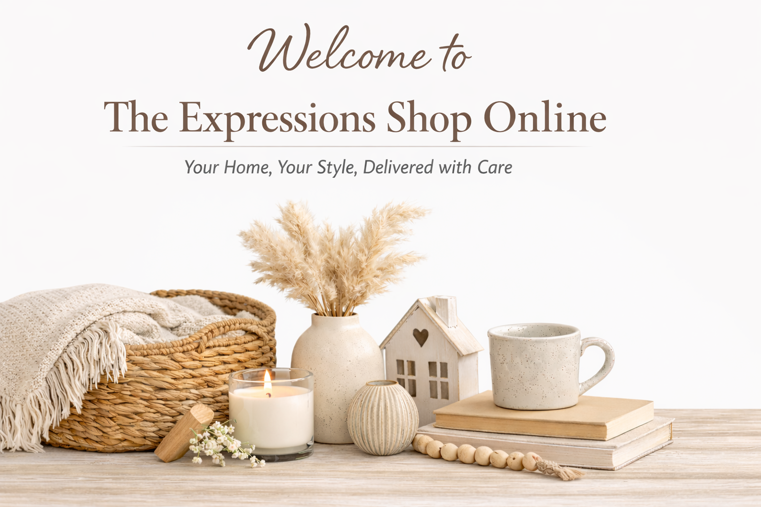 Decorative image showcasing cozy home decor items including a woven basket with a throw blanket, a white vase with dried pampas grass, a candle, a miniature house figurine, a speckled coffee mug on top of books, and a beaded garland, with welcoming text for an online shop.