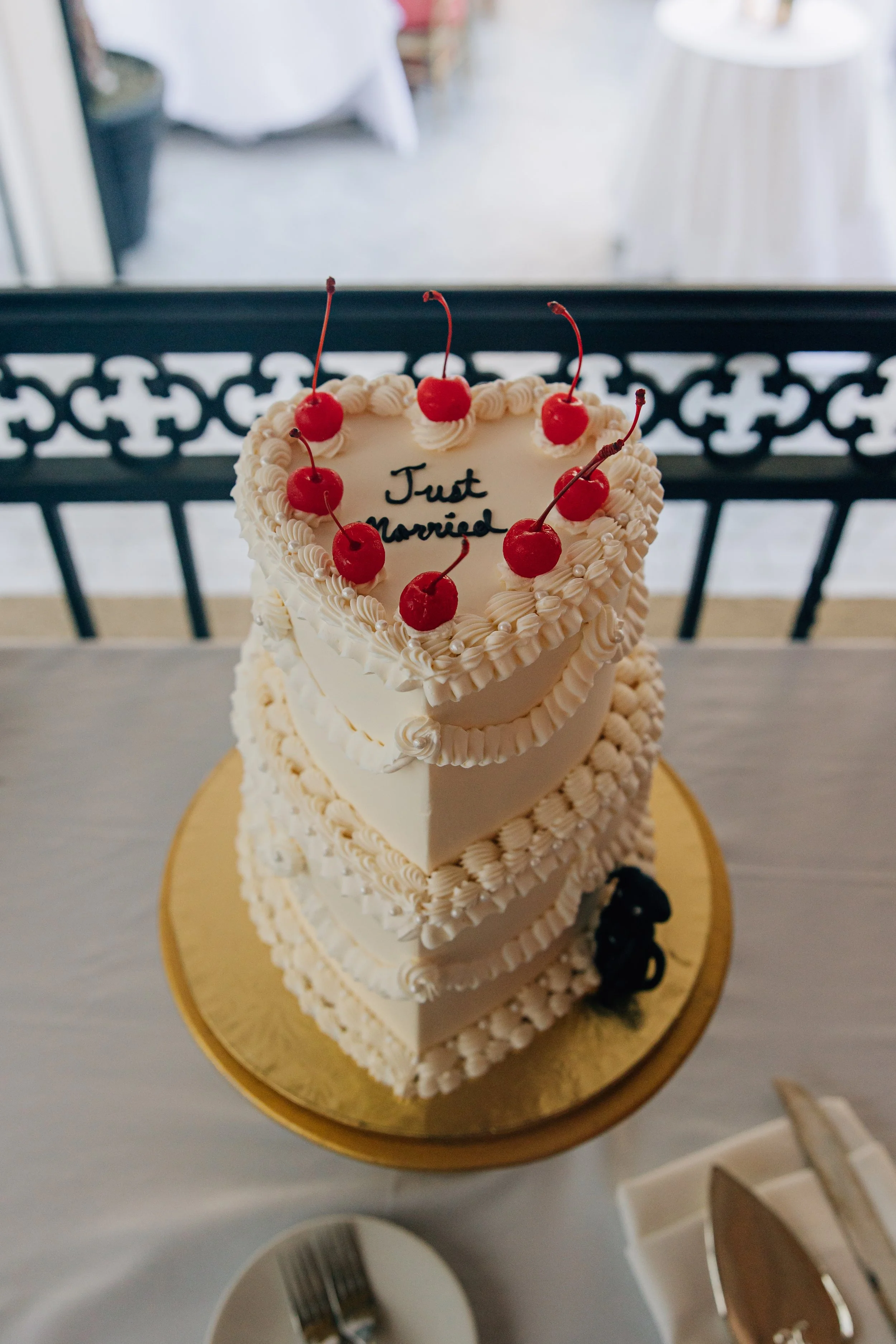 Heart shaped. smooth white buttercream. White vintage piping with pearls. Cherries on top. To say _Just Married_ in black script. Fondant dog.3.jpg