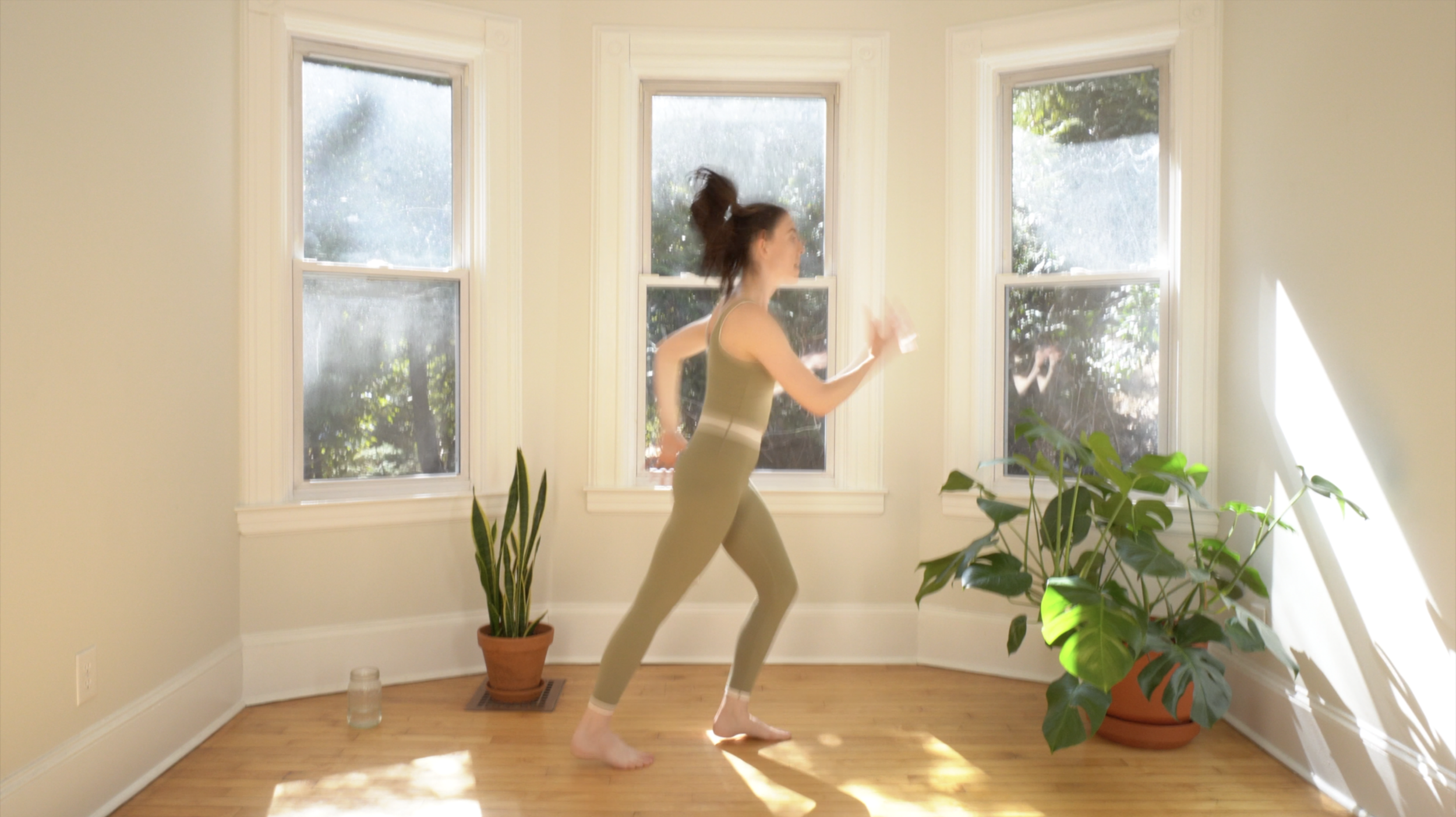 Still image from a high-energy cardio workout on The Playground fitness platform, featuring Meredith Witte in motion.