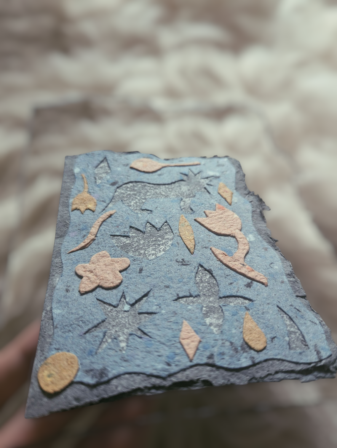 Felsen mit eingeritzten und bemalten Mustern, Blumen und geometrischen Formen.