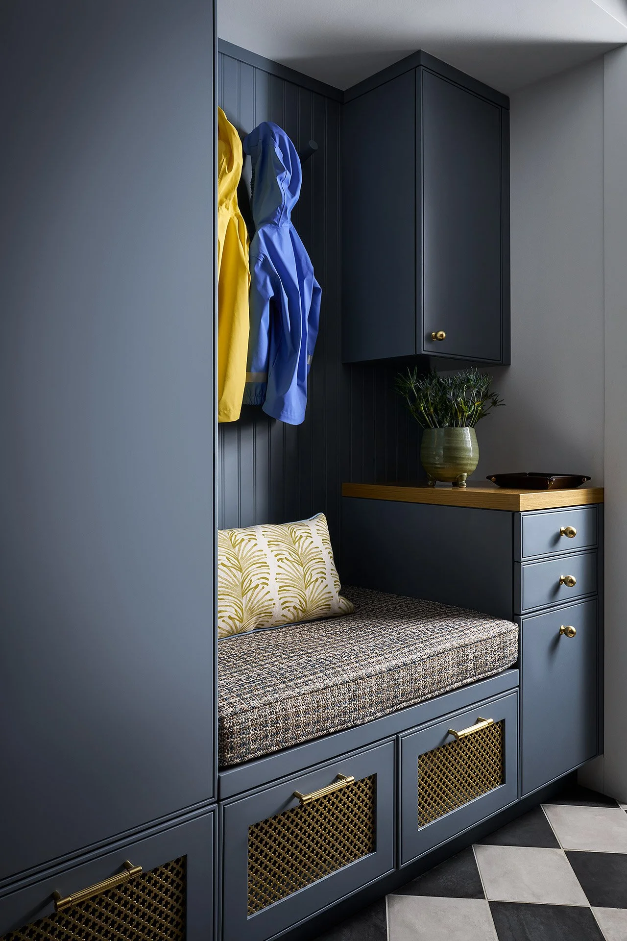 A moody mudroom with checker board tile