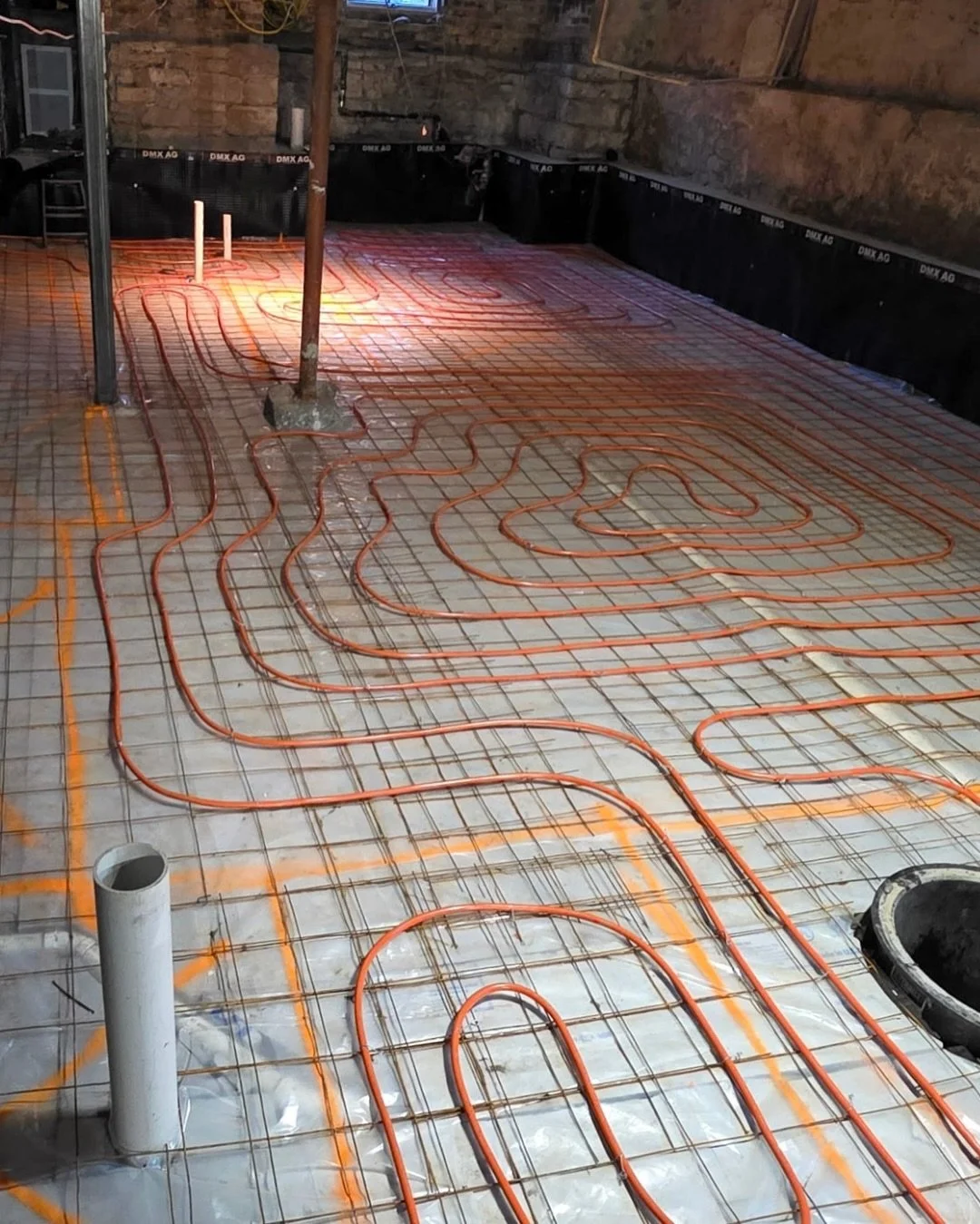 Ever wonder how radiant floor heat gets installed in basements?

There are lots of benefits of hydronic floor heating:
- Save on heating costs
- Energy efficient
- Cleaner airflow 
- Cozy in the winter

There are a lot of layers that go into a long-l