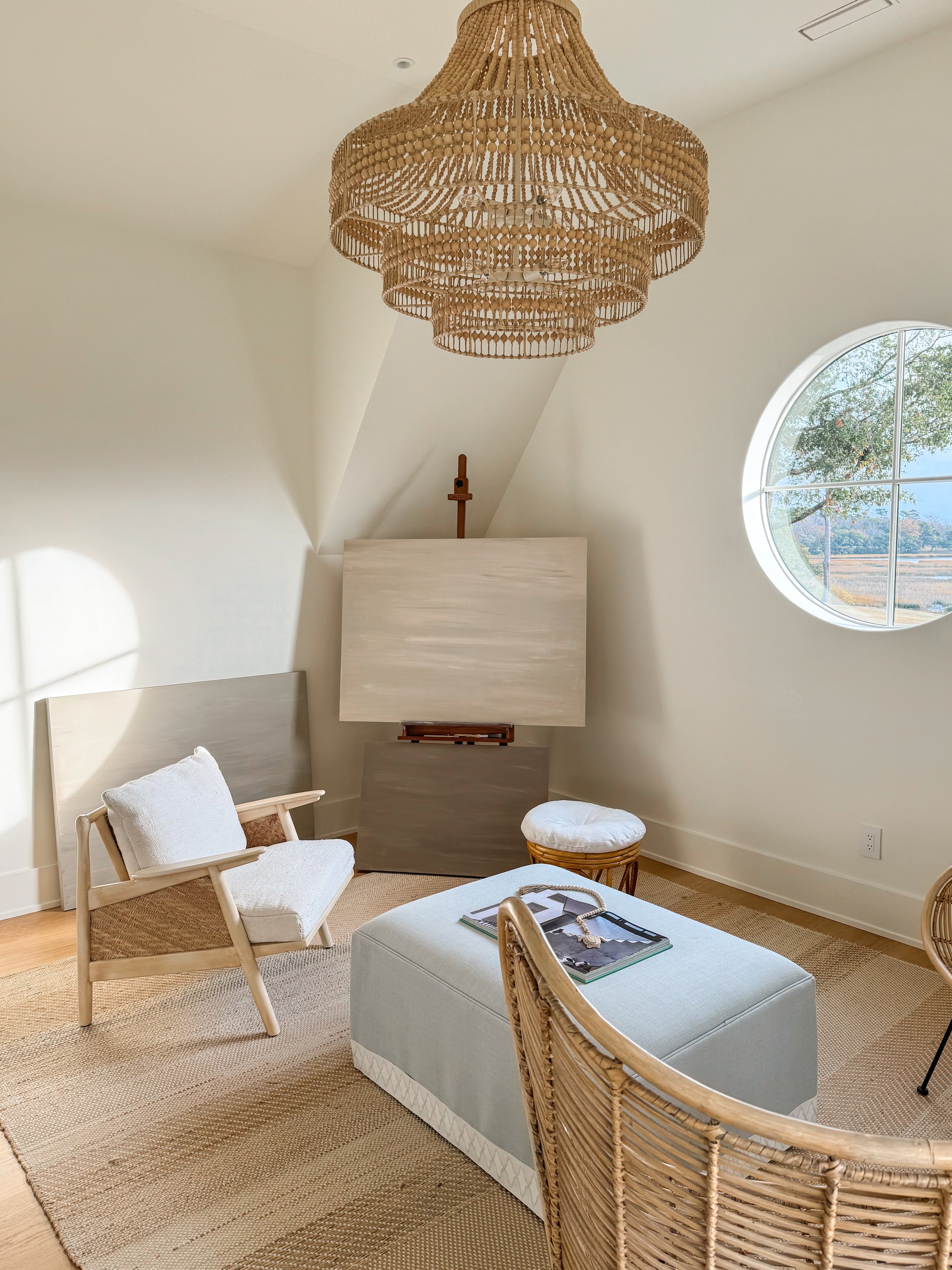 Interior view of Christie Raju’s home studio with acrylic paintings and natural light.