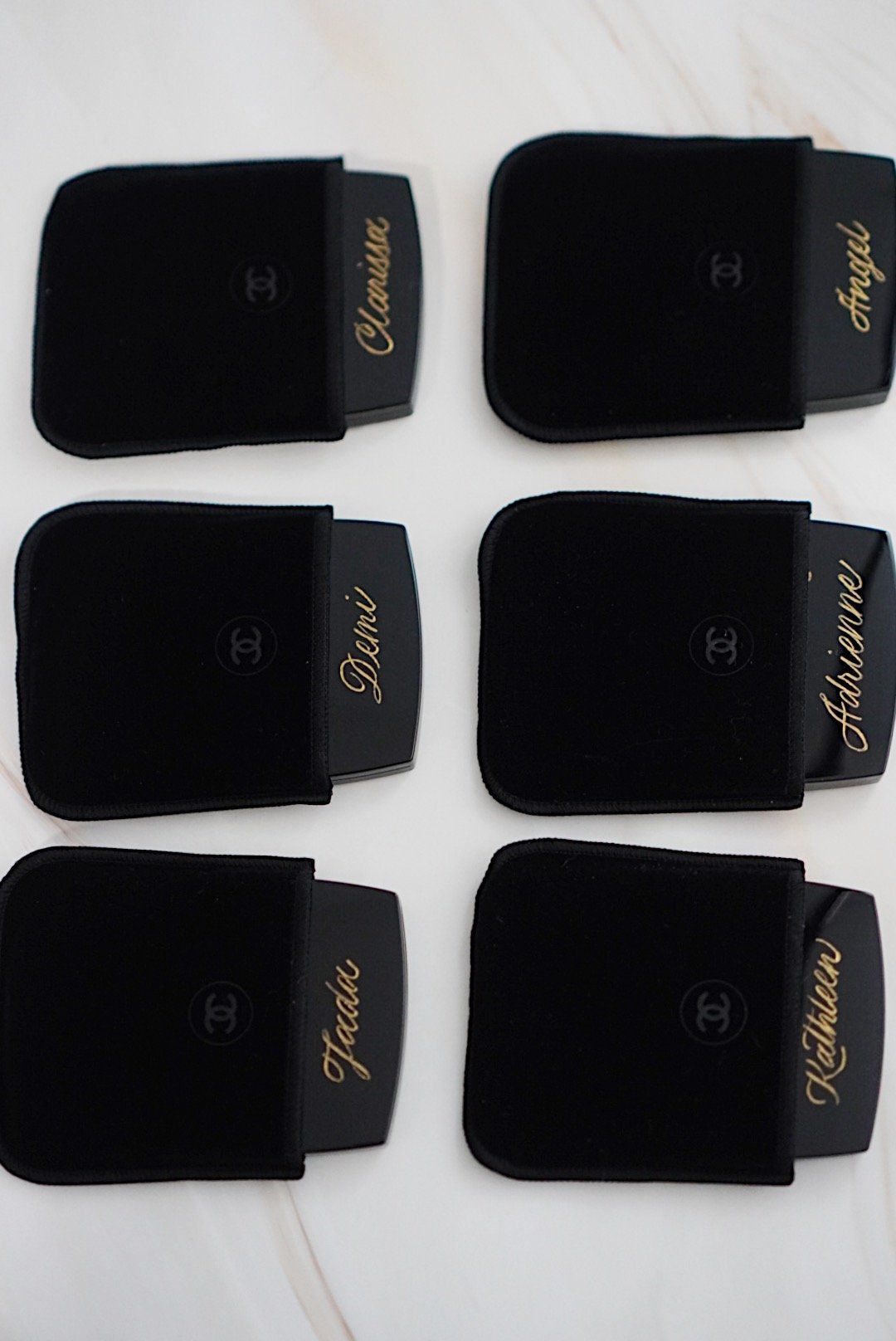 Hand engraved Chanel compact mirrors personalized with names for a bridal party in Toronto