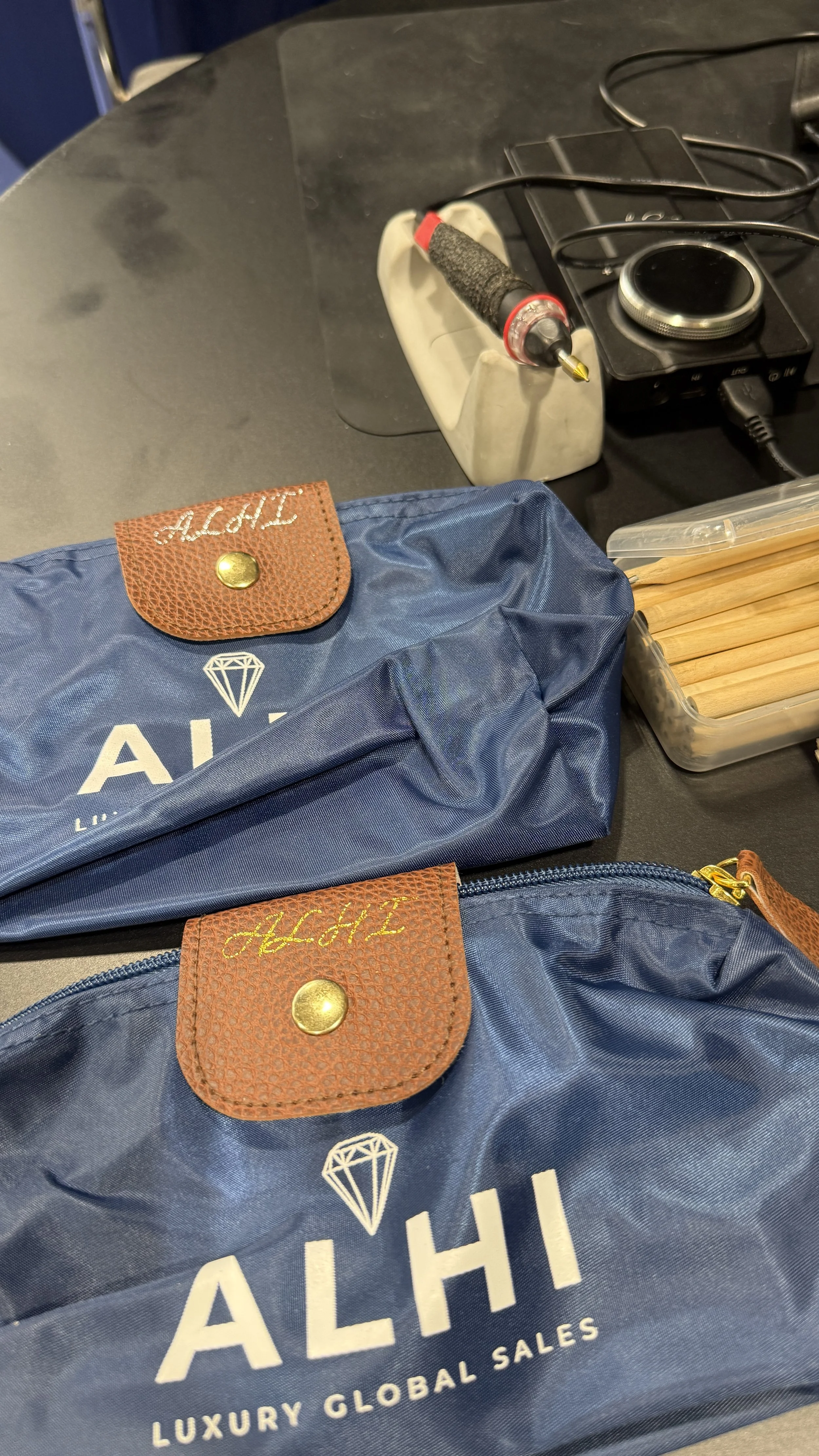 Live hot foiling on personalized pouches for ALHI at Canadian Meetings and Events Expo in Toronto