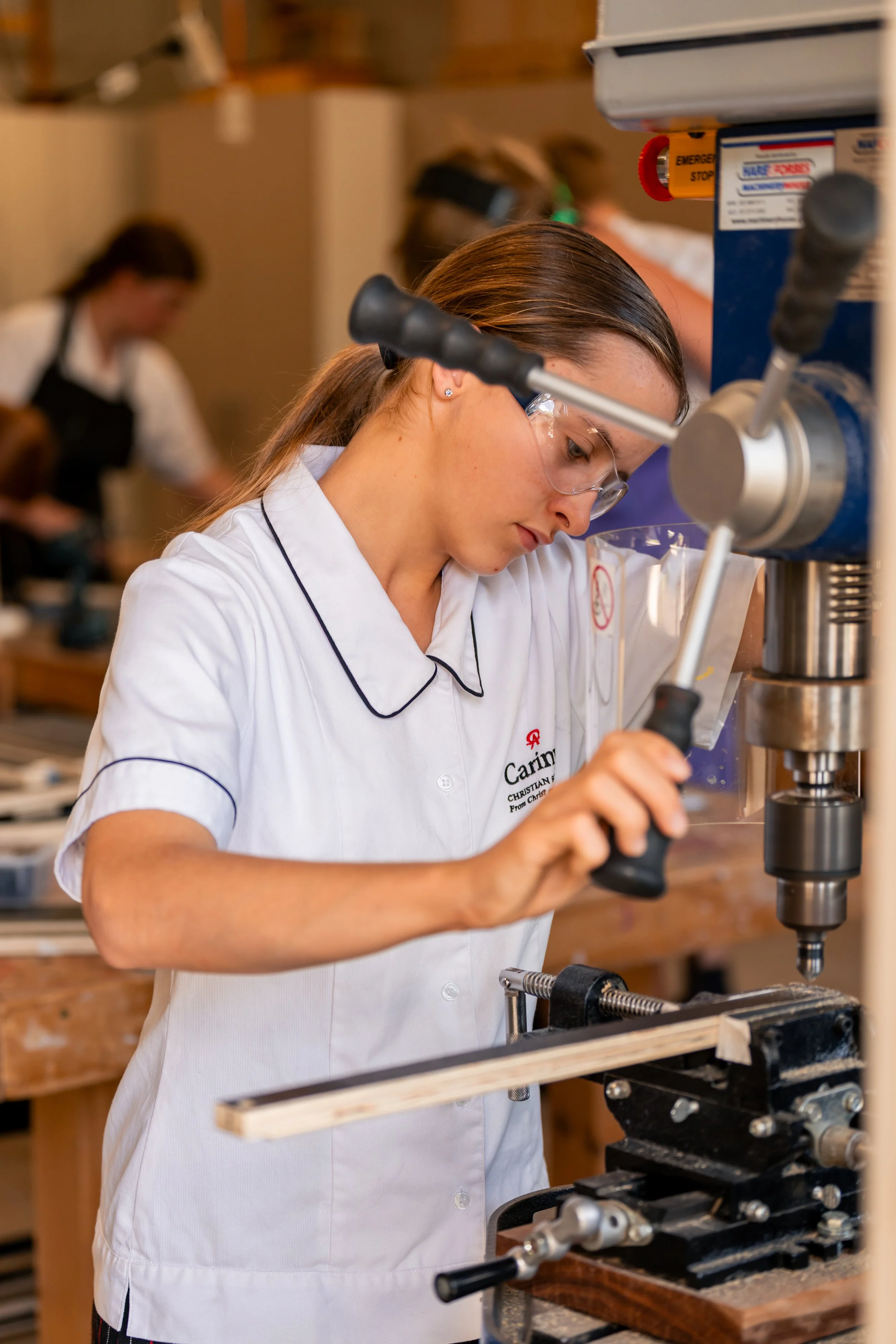 Student working with a drill press in a design and technology classroom at Carinya Christian School, Gunnedah.
