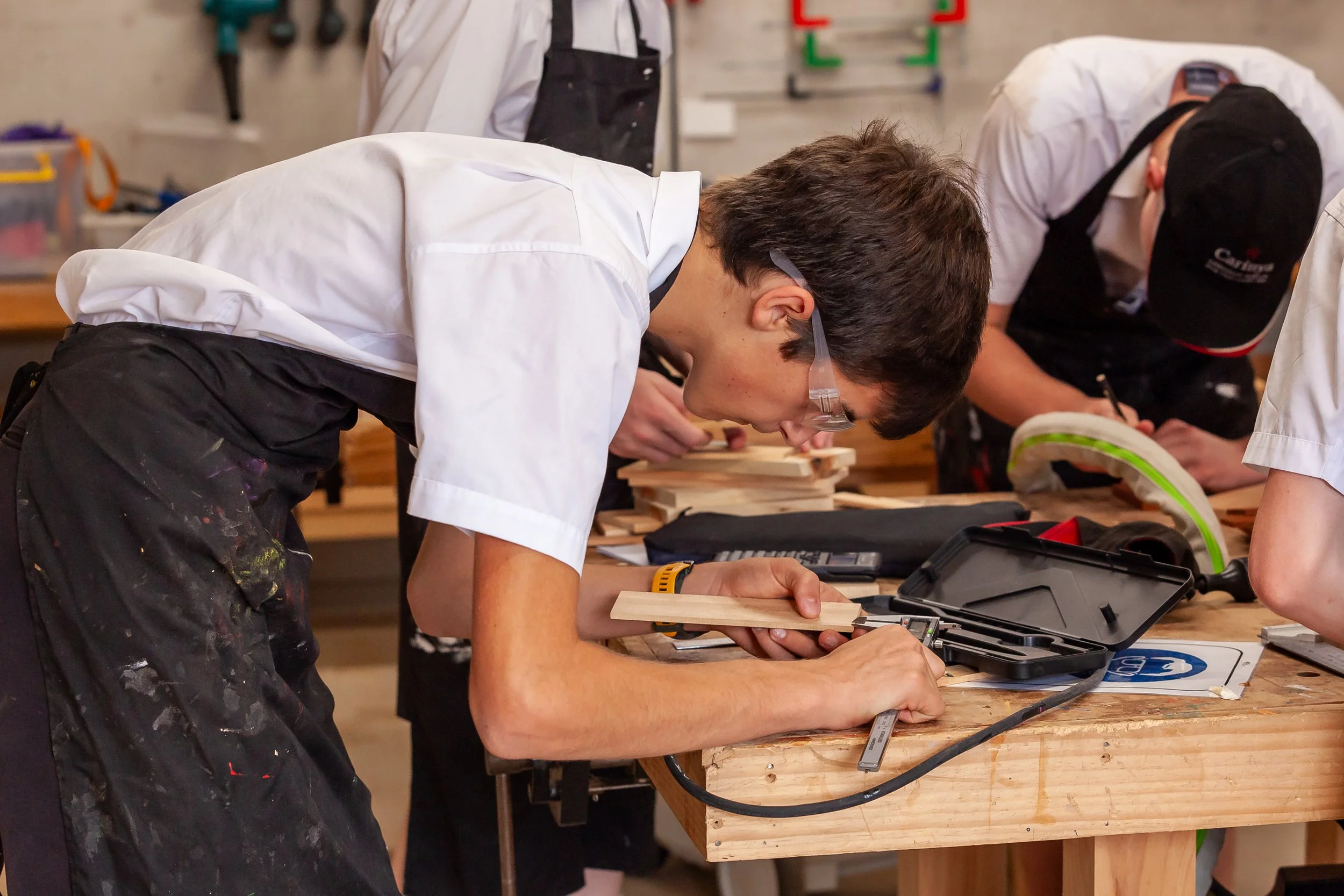 Students working together on a woodworking project in a design and technology classroom at Carinya Christian School, Gunnedah.
