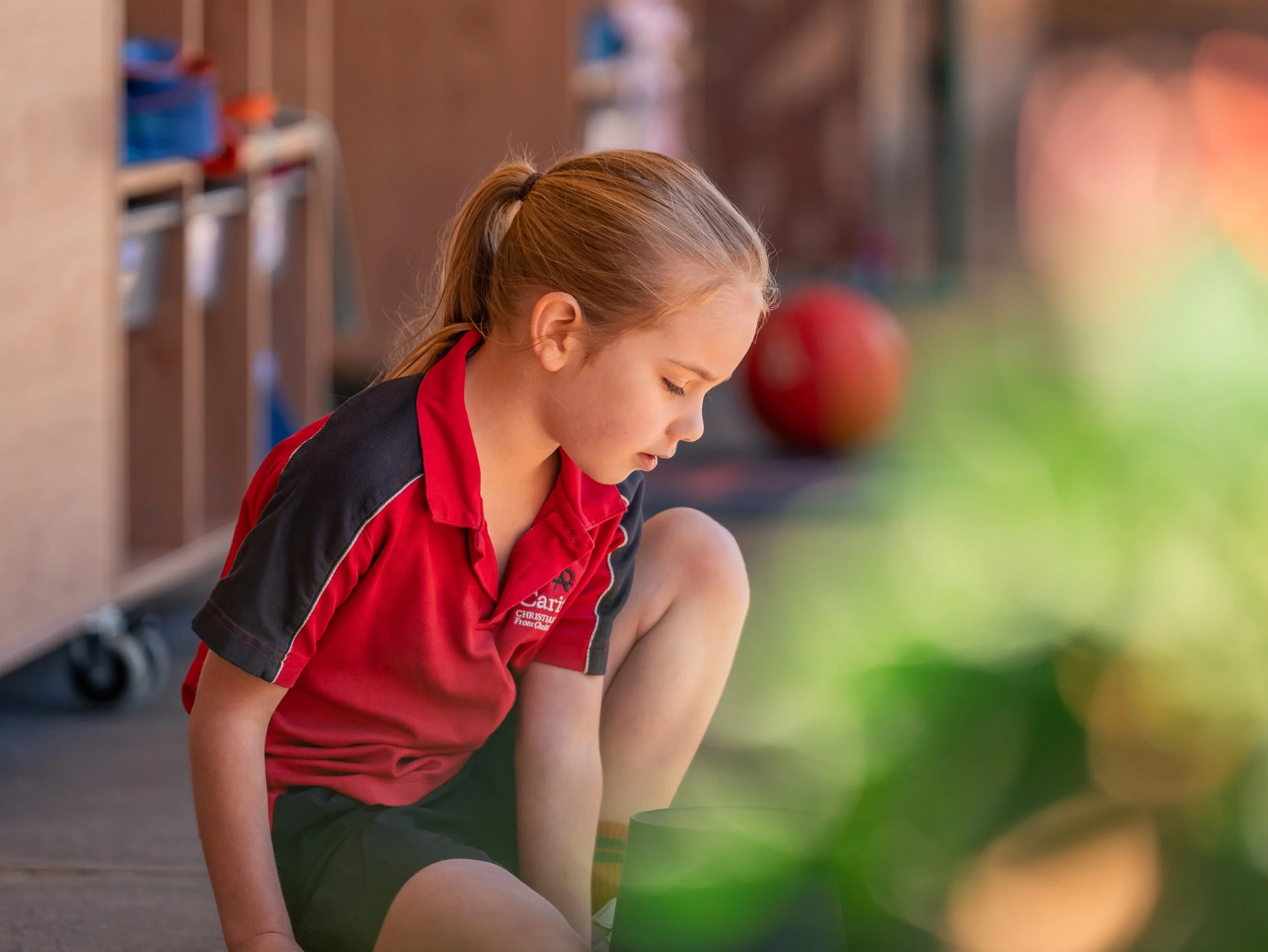 A Prep Student sitting outside of the Prep classroom at Carinya Christian School, Gunnedah.