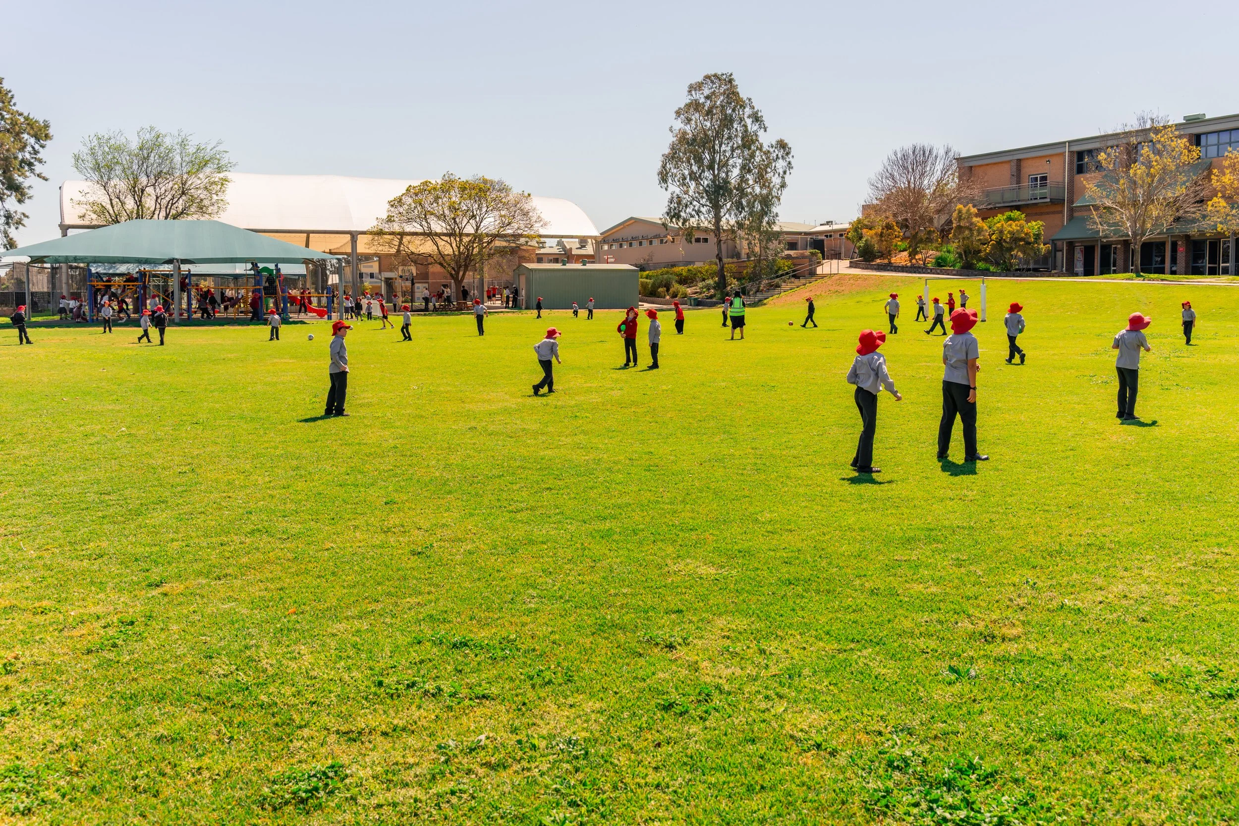 Junior School students playing sport on the large sports oval at Carinya Christian School, Tamworth.
