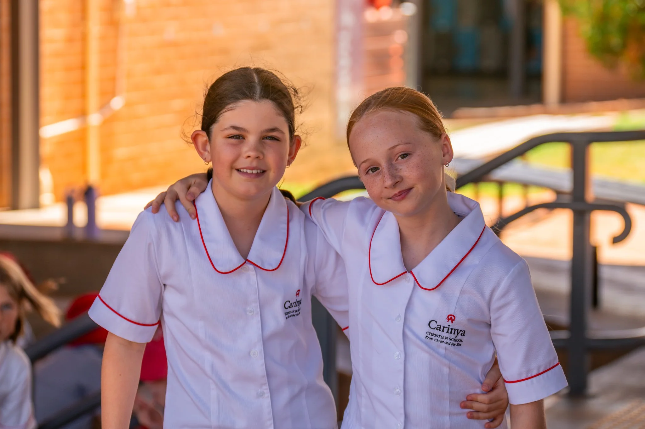 Two young female Junior School Students at Carinya Christian School, Tamworth, in the Junior School playground.