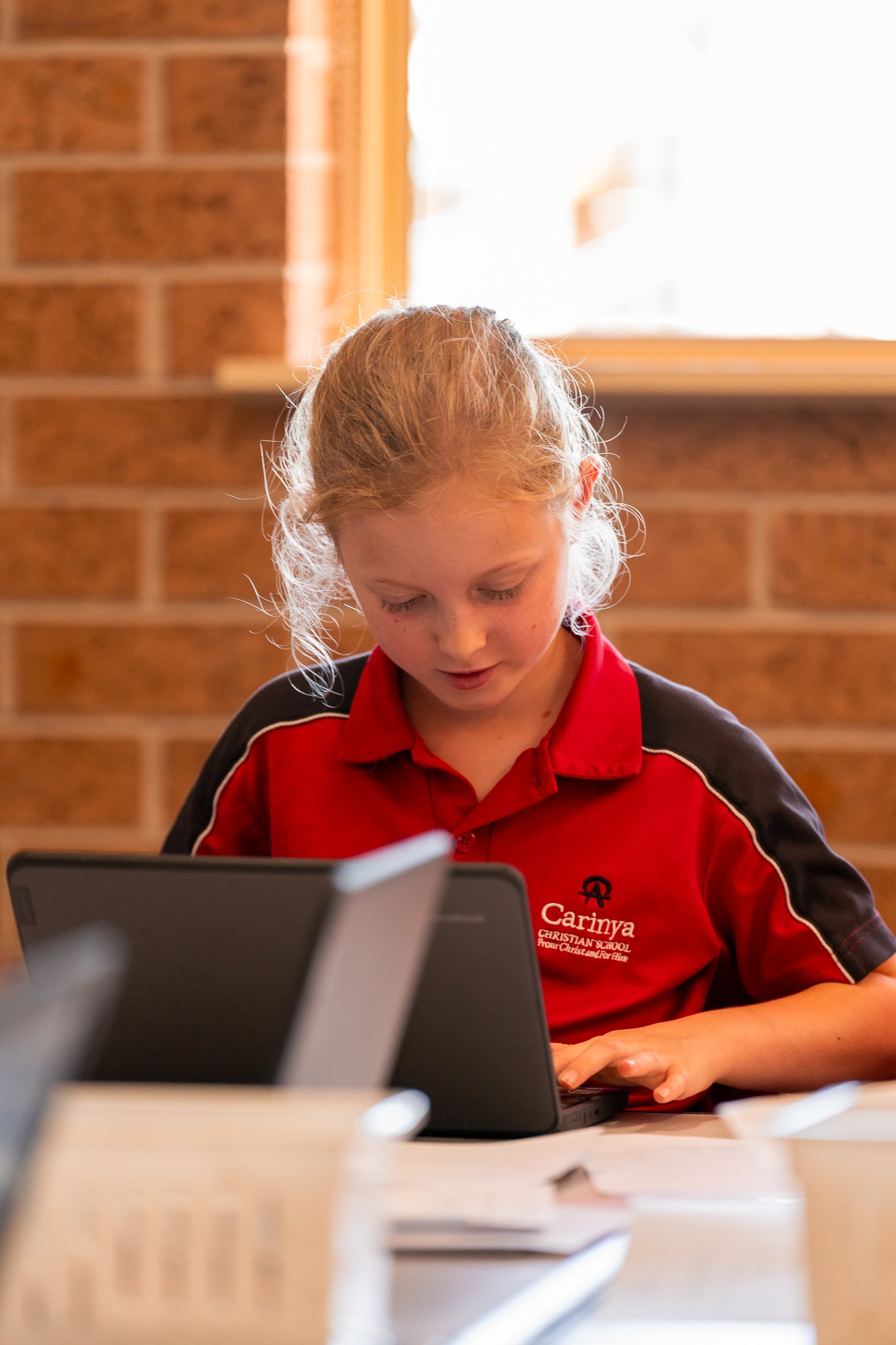 A Junior School student working on a project in a junior school classroom at Carinya Christian School, Tamworth.
