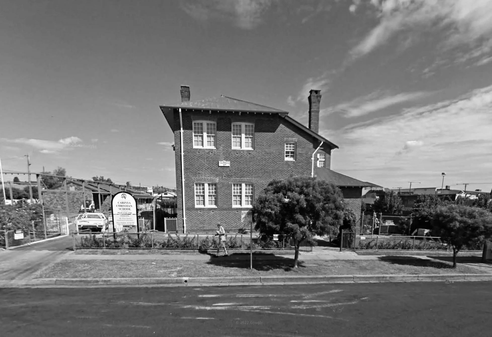 Historical photo of Carinya Christian School, Gunnedah, A black and white photo of a brick school building with three stories and multiple chimneys.