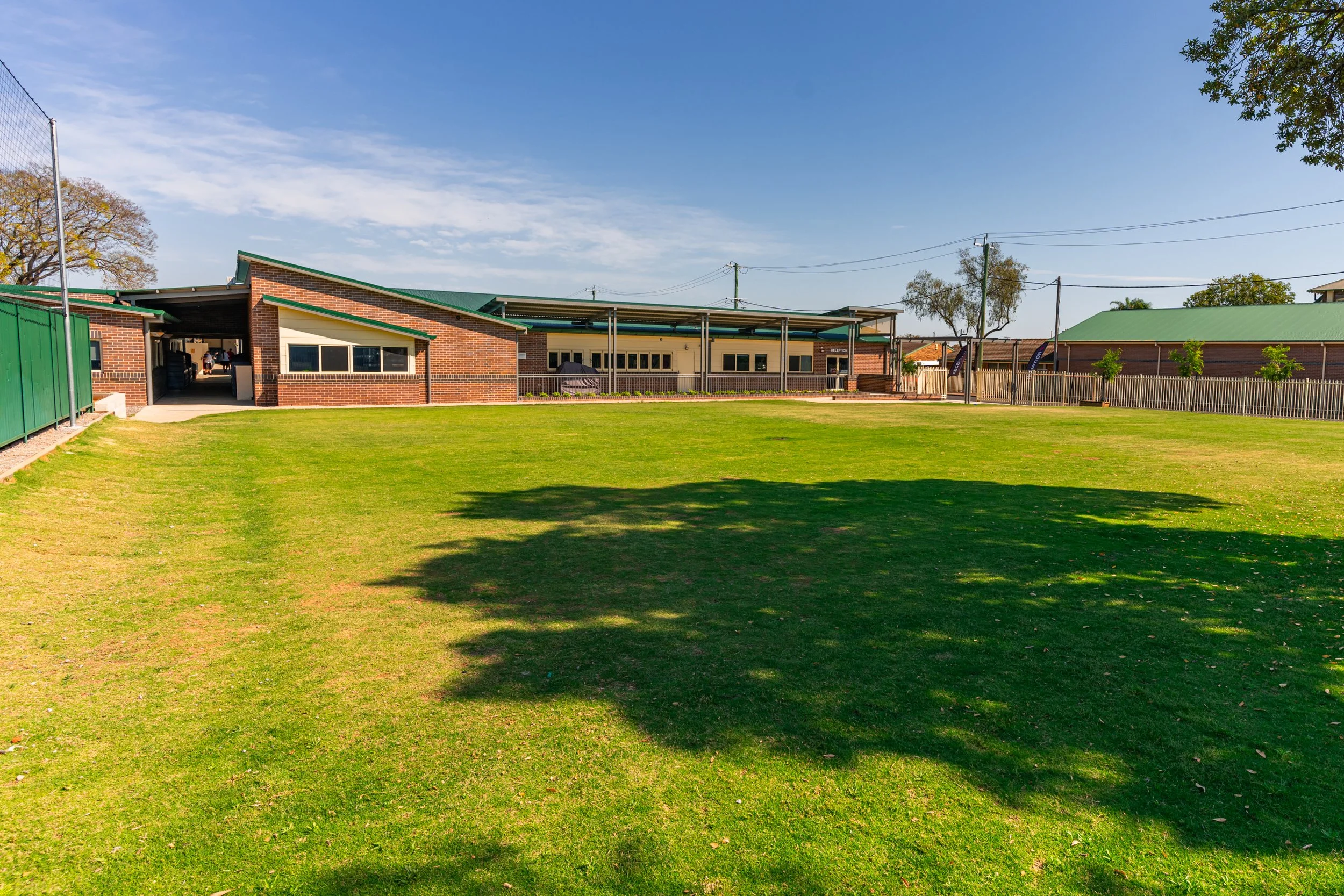 A photo of a large sports oval and Senior / Middle School buildings at Carinya Christian School, Gunnedah.