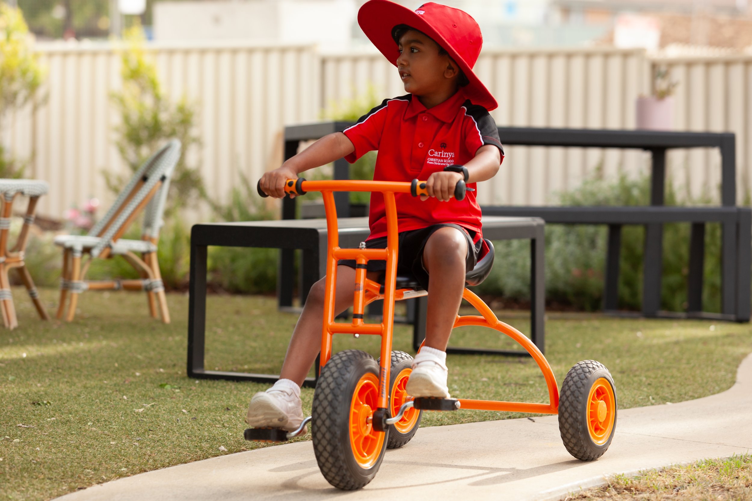 A Child riding a bike at Lilly Pilly Prep in the outdoor play area at Carinya Christian School, Tamworth