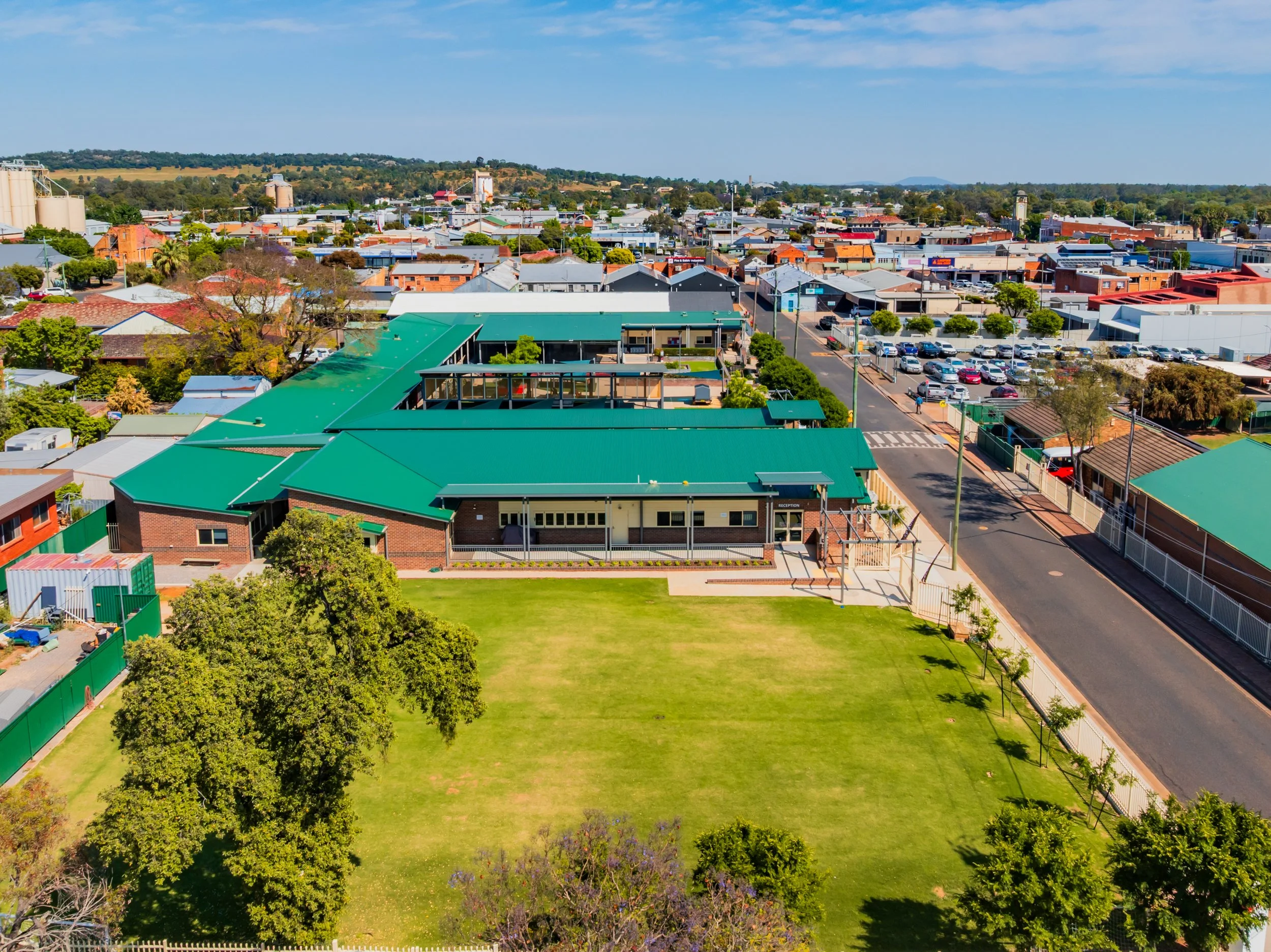 An aerial view of a large sports oval and Senior / Middle School buildings at Carinya Christian School, Gunnedah.