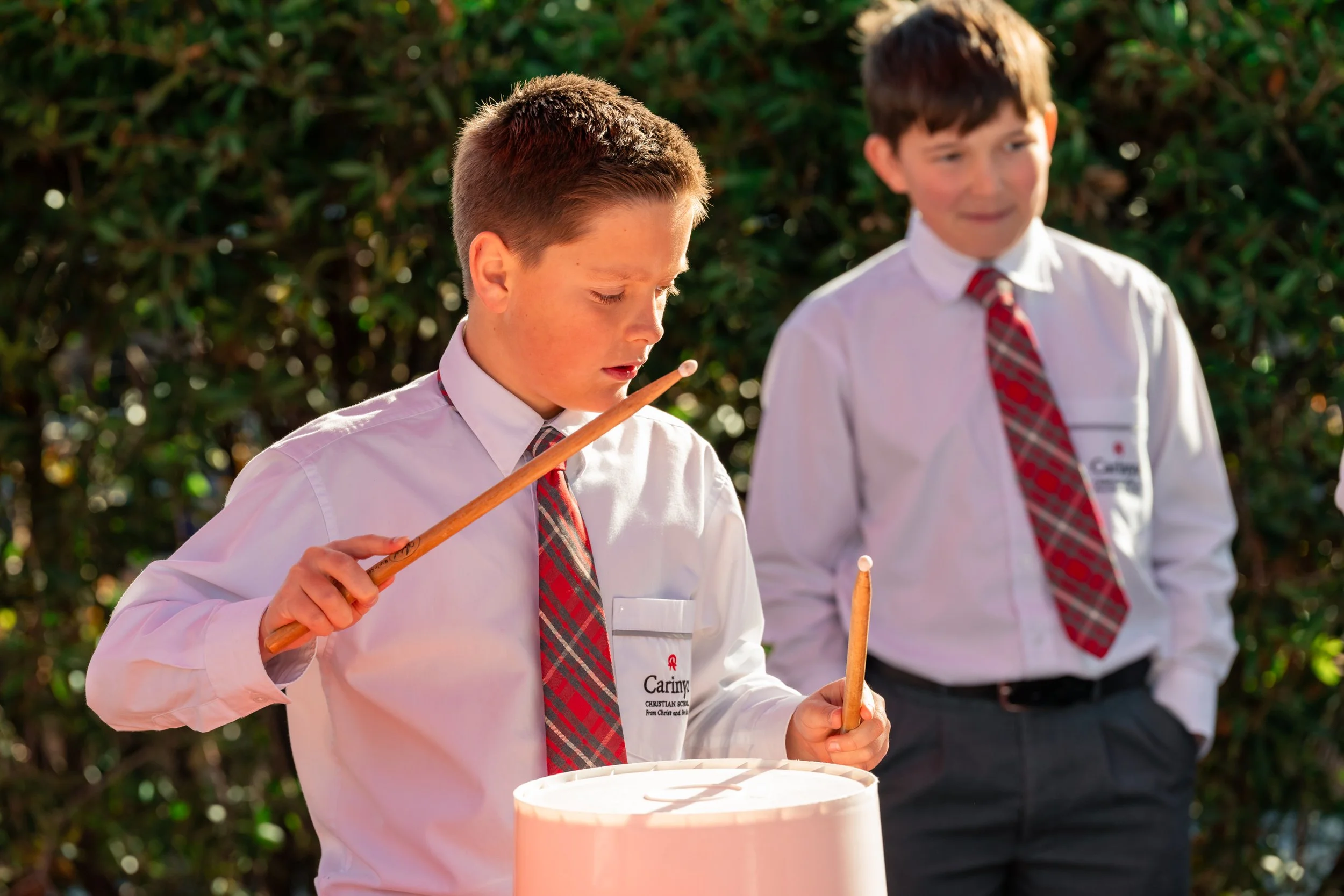 Two young male Middle School Students at Carinya Christian School, Tamworth, in the Middle School playground.