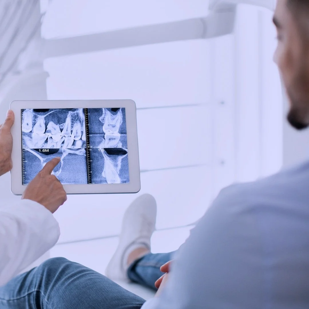 XO Smiles patient in chair looking at cbct pic.jpg