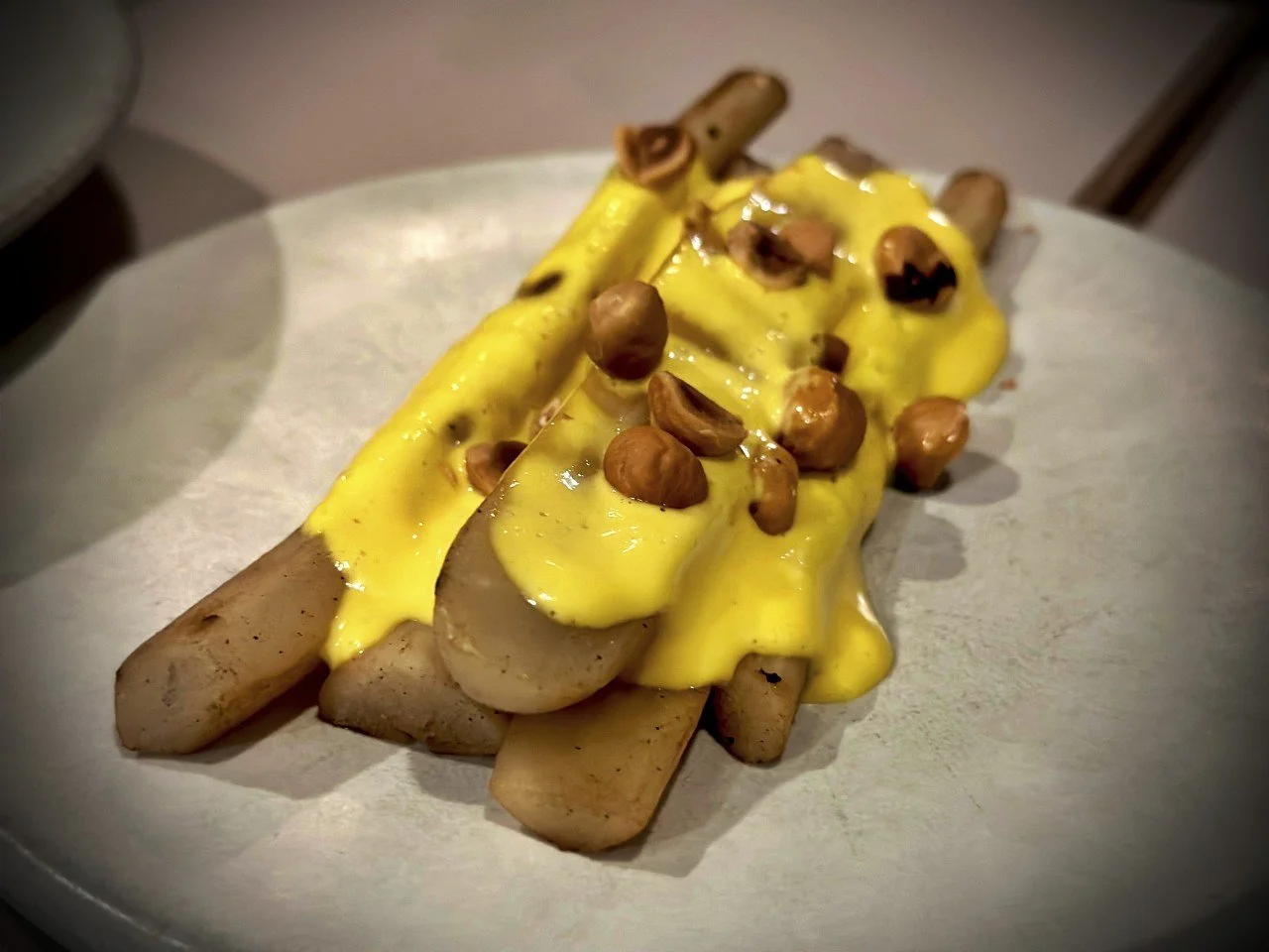 Regional asparagus served with a creamy sauce and toasted hazelnuts at Otto restaurant. The arrangement embodies Vadim’s approach of reducing a dish to the essence of a high-quality product.