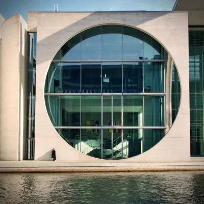 The Marie-Elisabeth-Lüders-Haus with its exposed concrete facade and striking circular window on the Spree. An example of modern design within Berlin's government district.