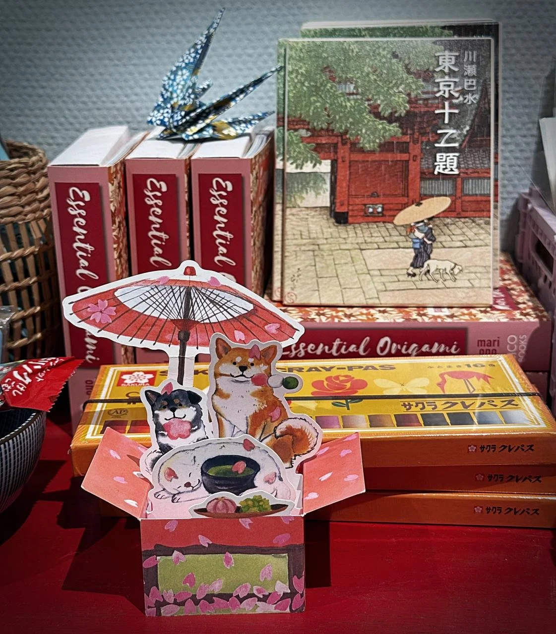 Cherry blossom motifs and Japanese characters decorate the notebooks and postcards at the Sakura Copenhagen store in Frederiksberg. Various art books are placed on the shelves alongside the stationery.