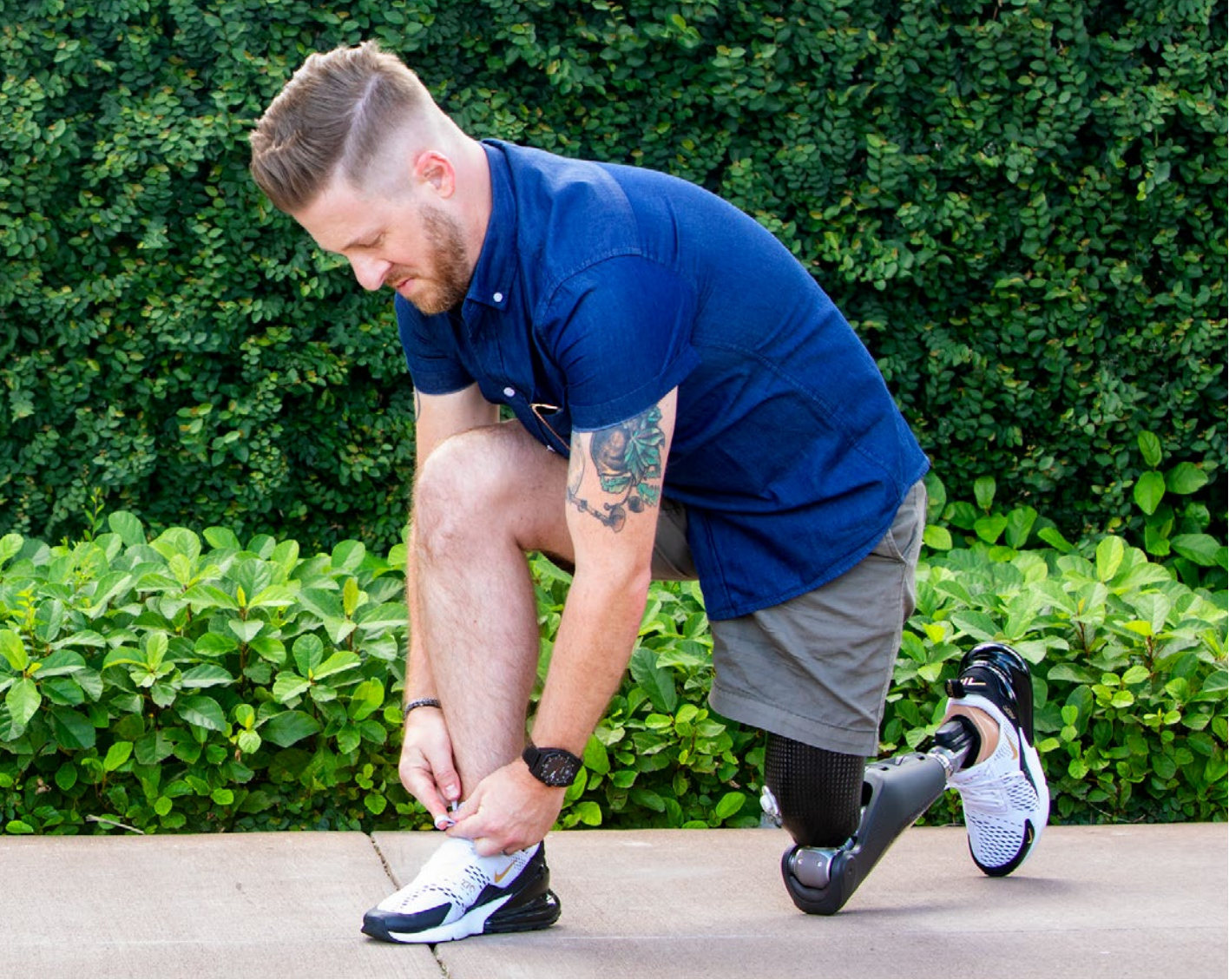 Man tying shoe with prosthetic leg