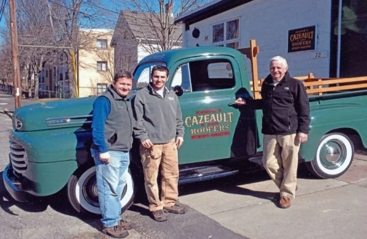 Family infront of green company truck.