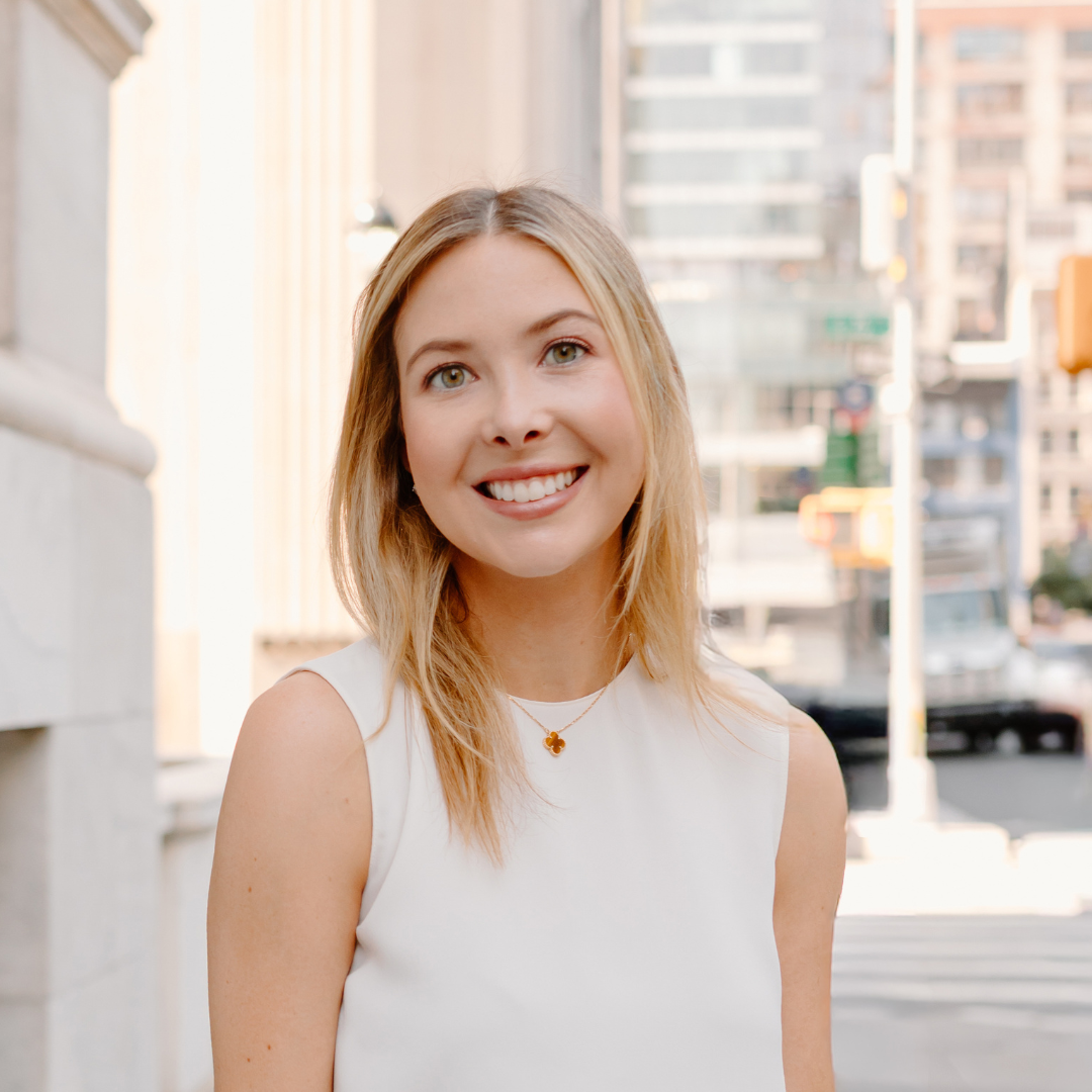 Smiling woman with New York City Street behind her