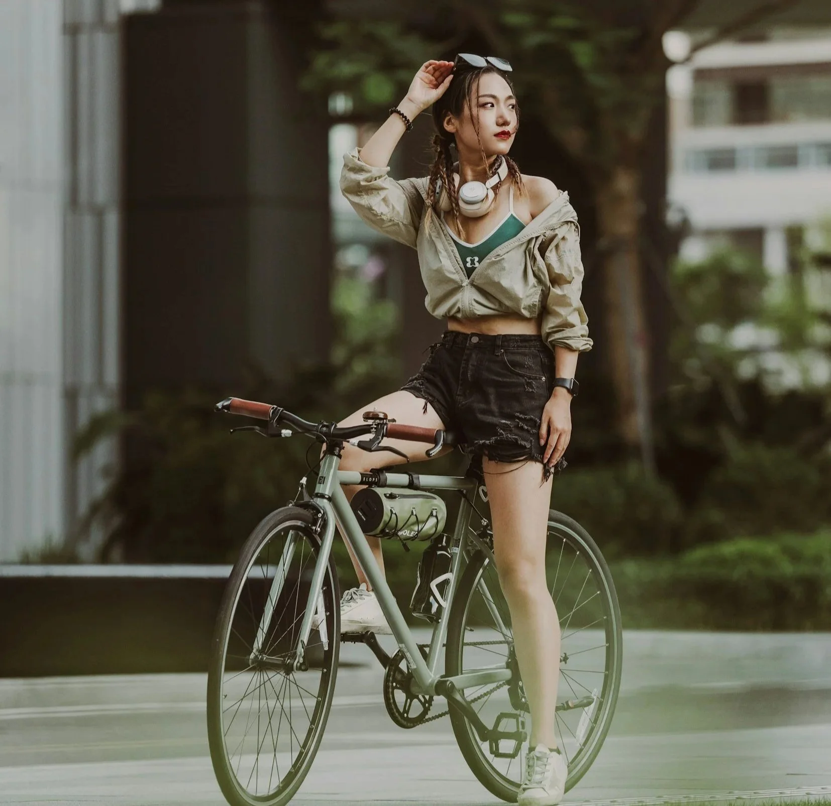 young woman sitting on bike