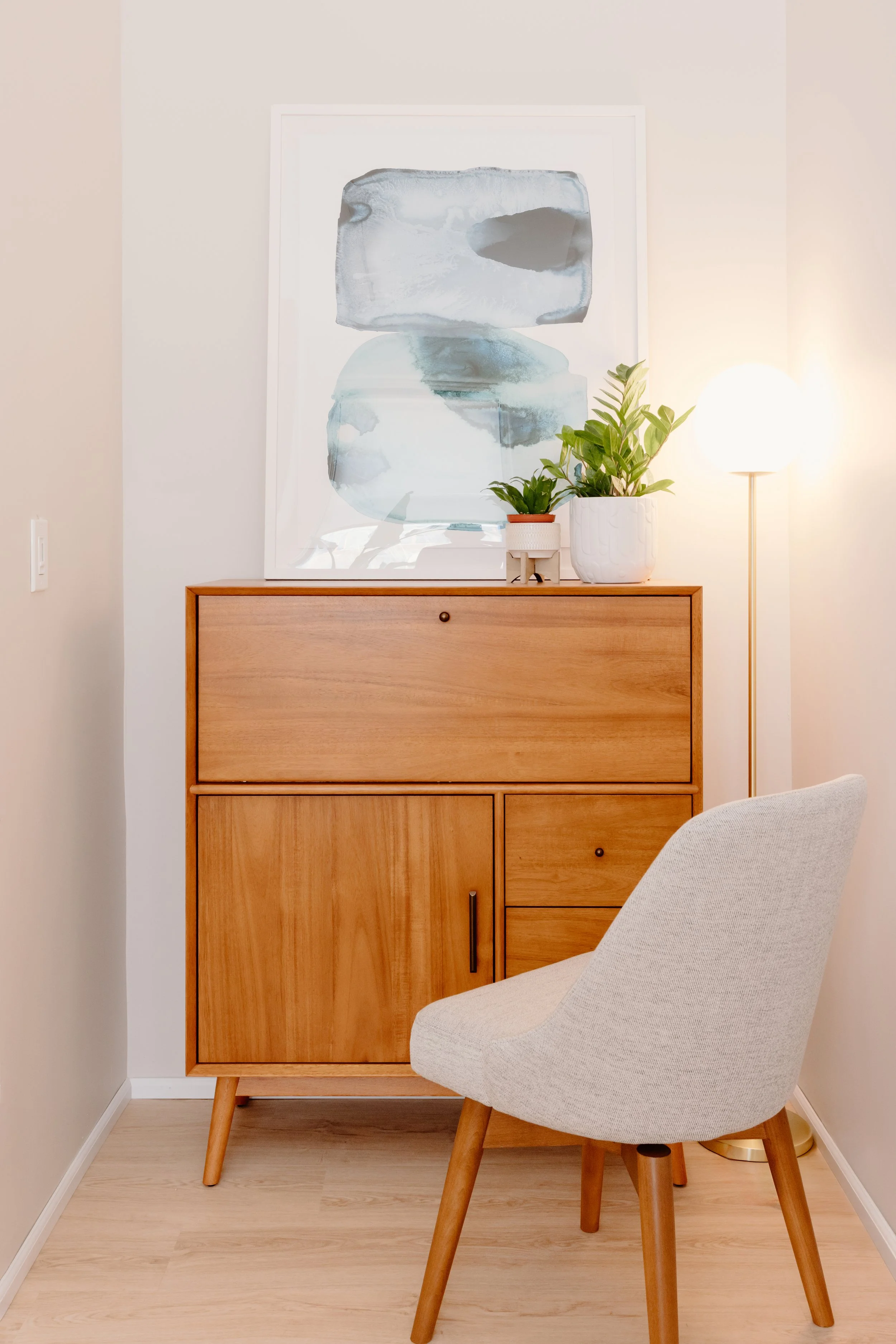 midcentury modern secretary desk with desk chair in front of it.