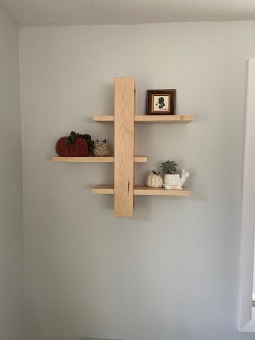 Maple floating sliding shelf on living room wall
