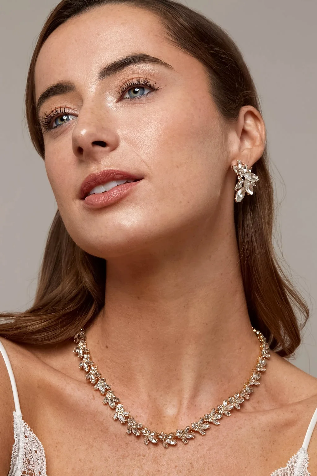 beautiful model wearing diamond jewelry set of necklace and earring in silver from olive and piper