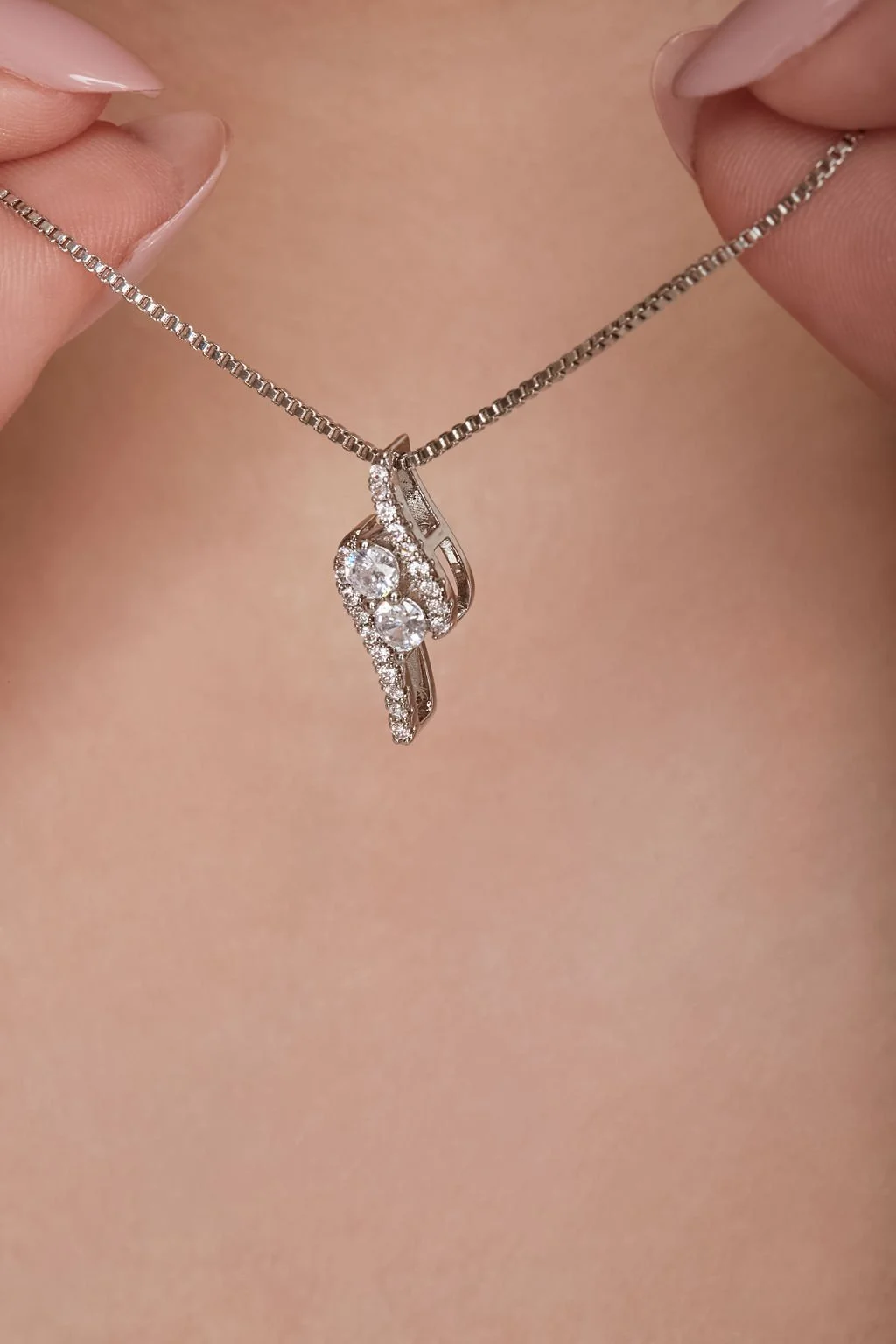 close up of beautiful diamond silver necklace pendant on delicate silver chain by finegraphy photography