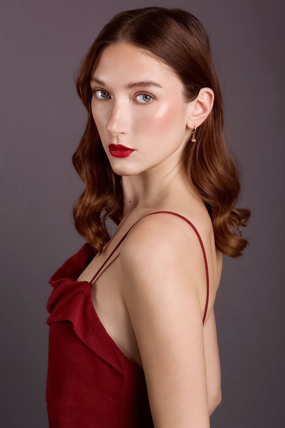 red haired professional model with red lip in red dress