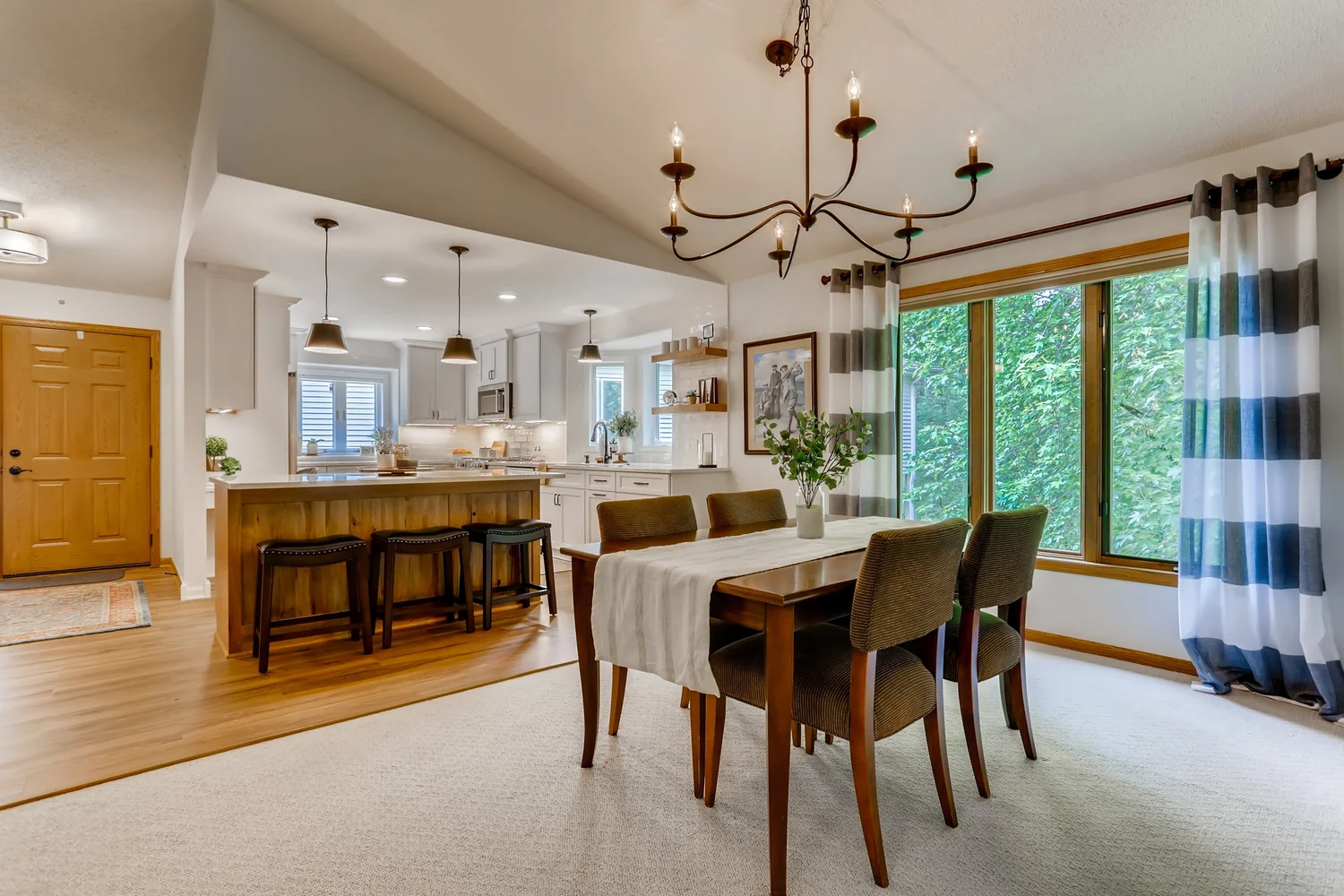 Stoneybridge kitchen-dining connection with partial wall opening in Minnetonka