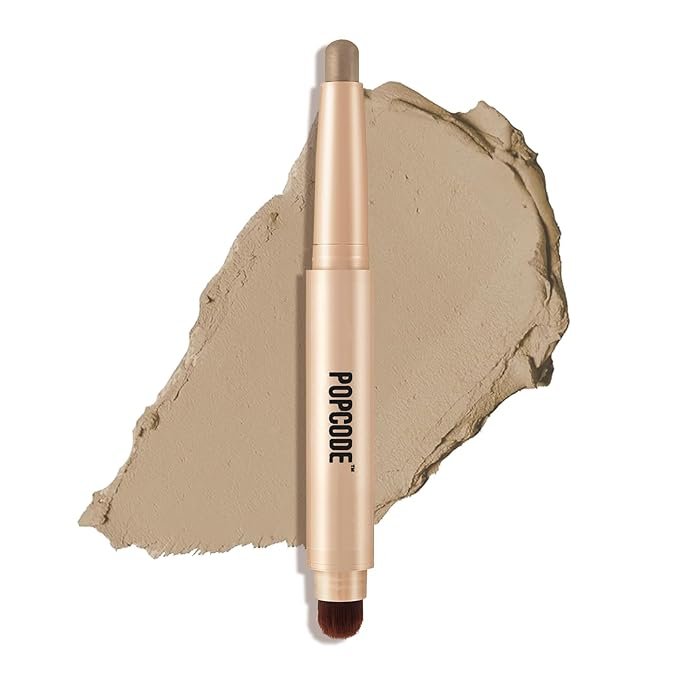 Cosmetic stick labeled 'POPCODE' with a cream smudge background, featuring dual ends with a brush and applicator.