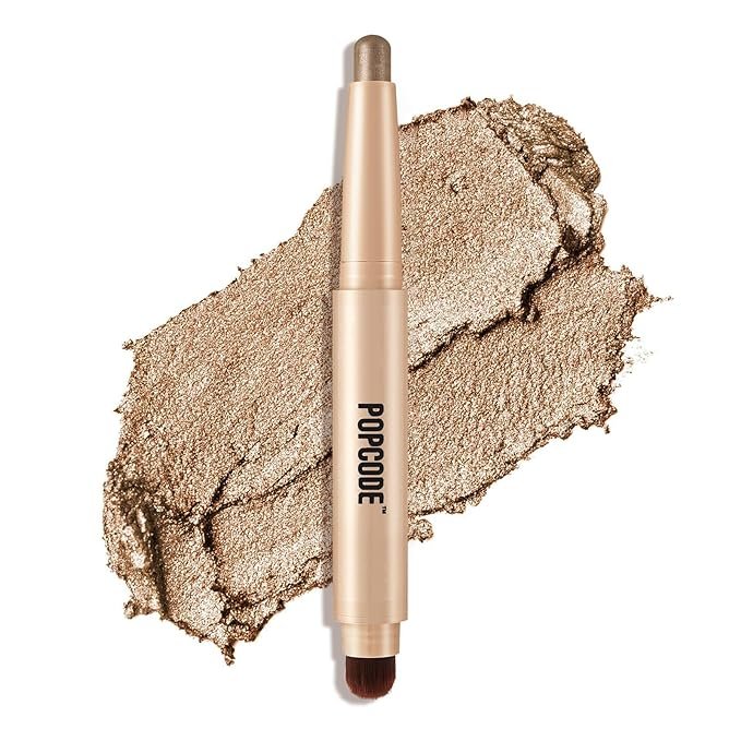 Gold makeup stick with brush and smear