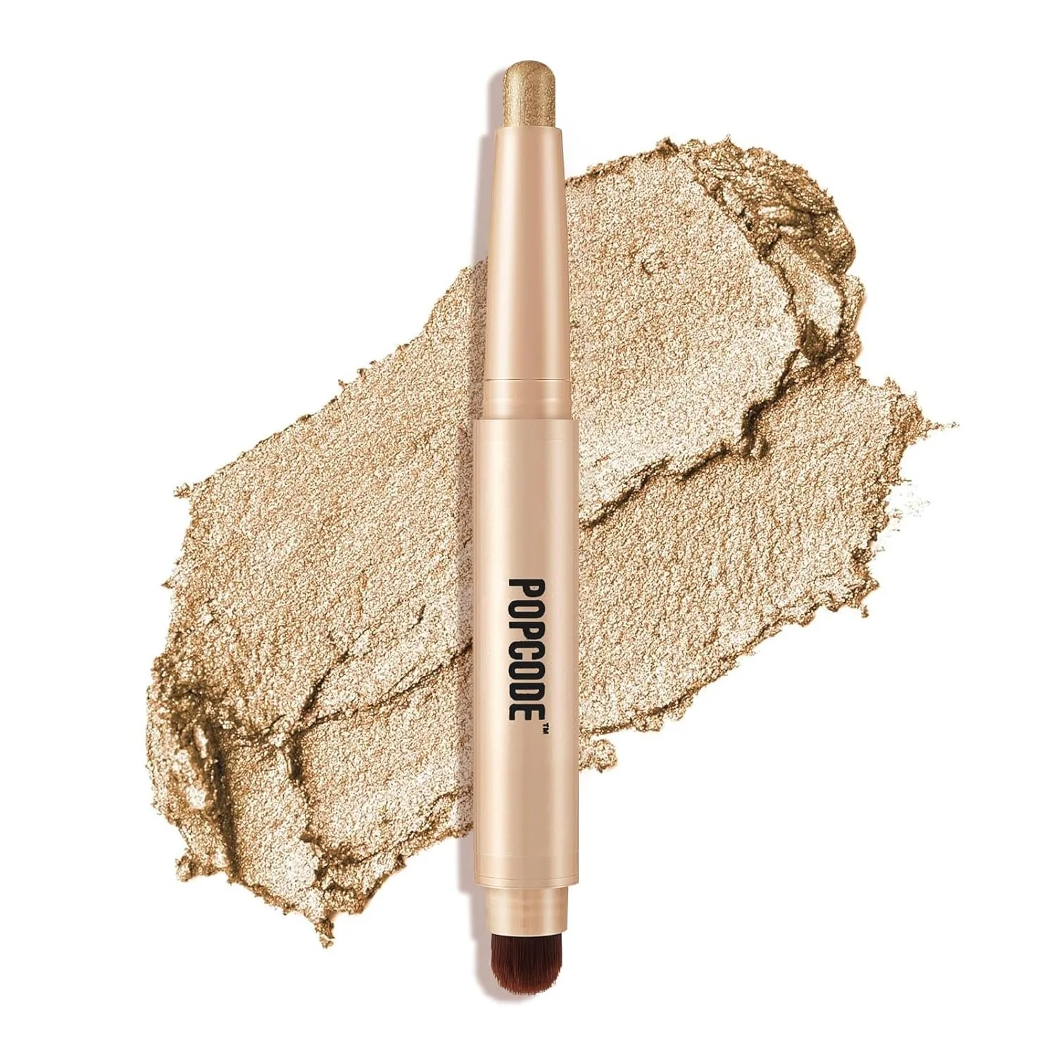 Gold eyeshadow stick labeled "POPCODE" with a smudged sample of the shade in the background.