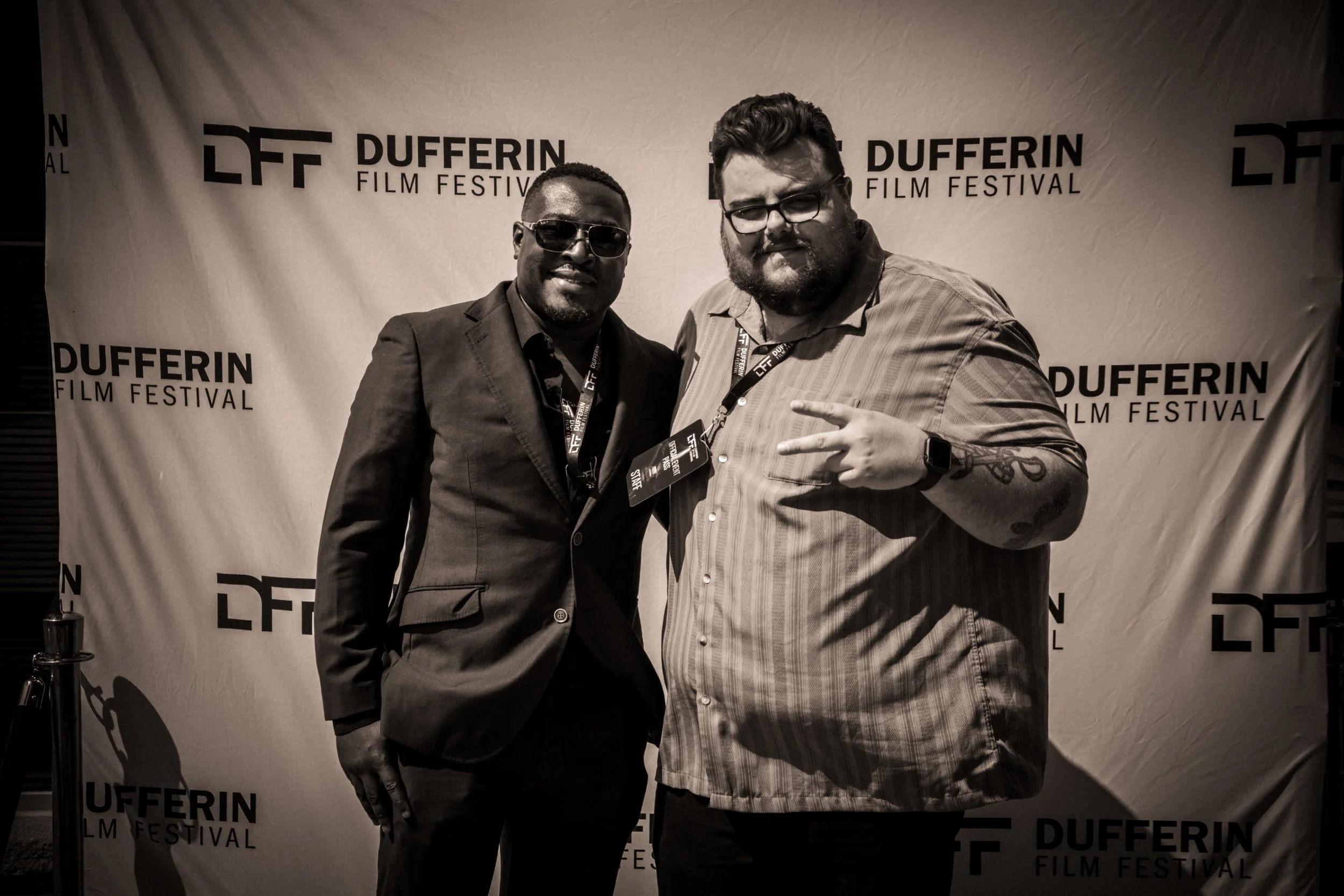 Two men posing at Dufferin Film Festival event backdrop.