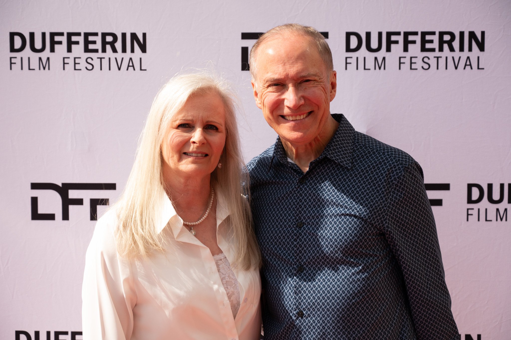 Two people smiling at the Dufferin Film Festival.