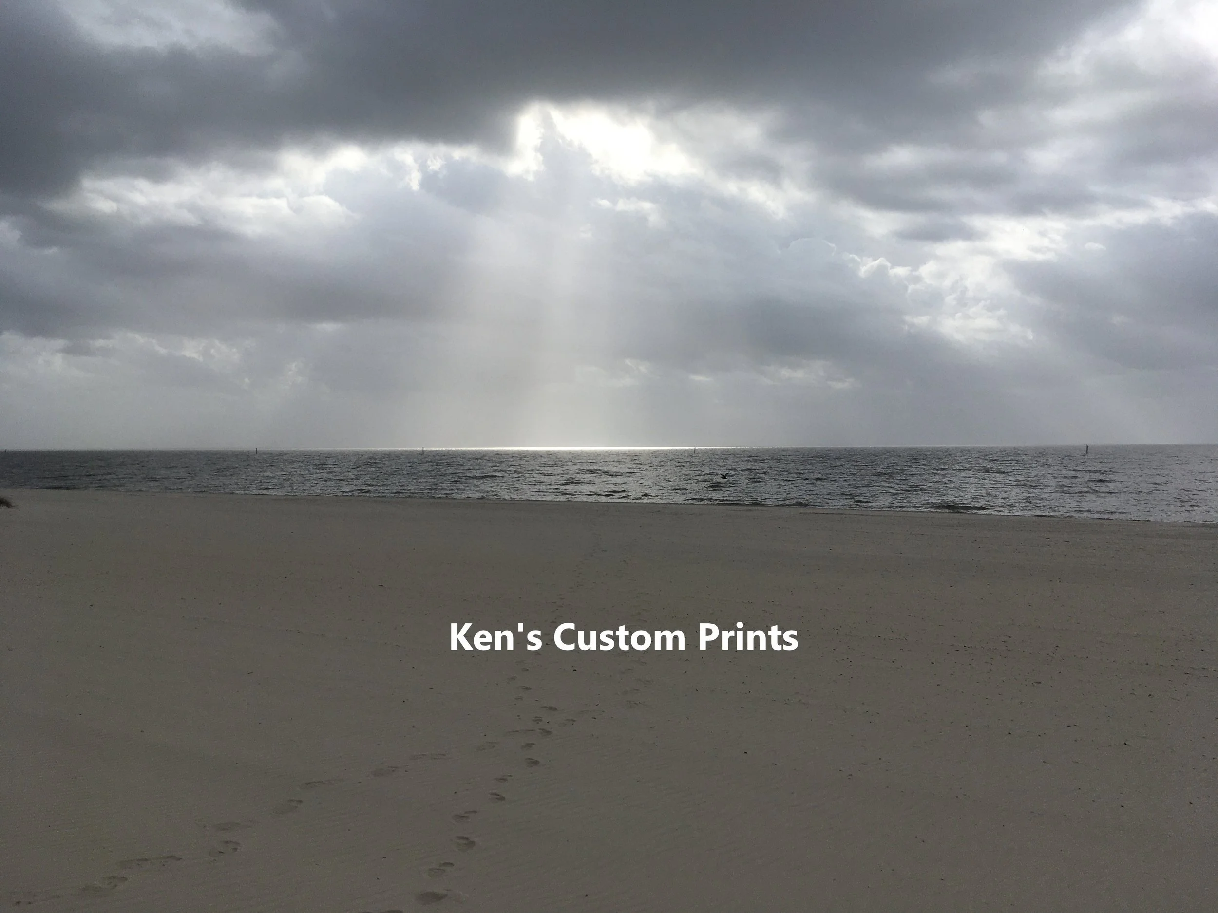 "Footsteps in the Sand" -  The rays of the sun breaking through the clouds seemed to beckon me toward its source. Closer observation after taking the photograph revealed footsteps in the sand appearing to lead just in the direction of the rays.