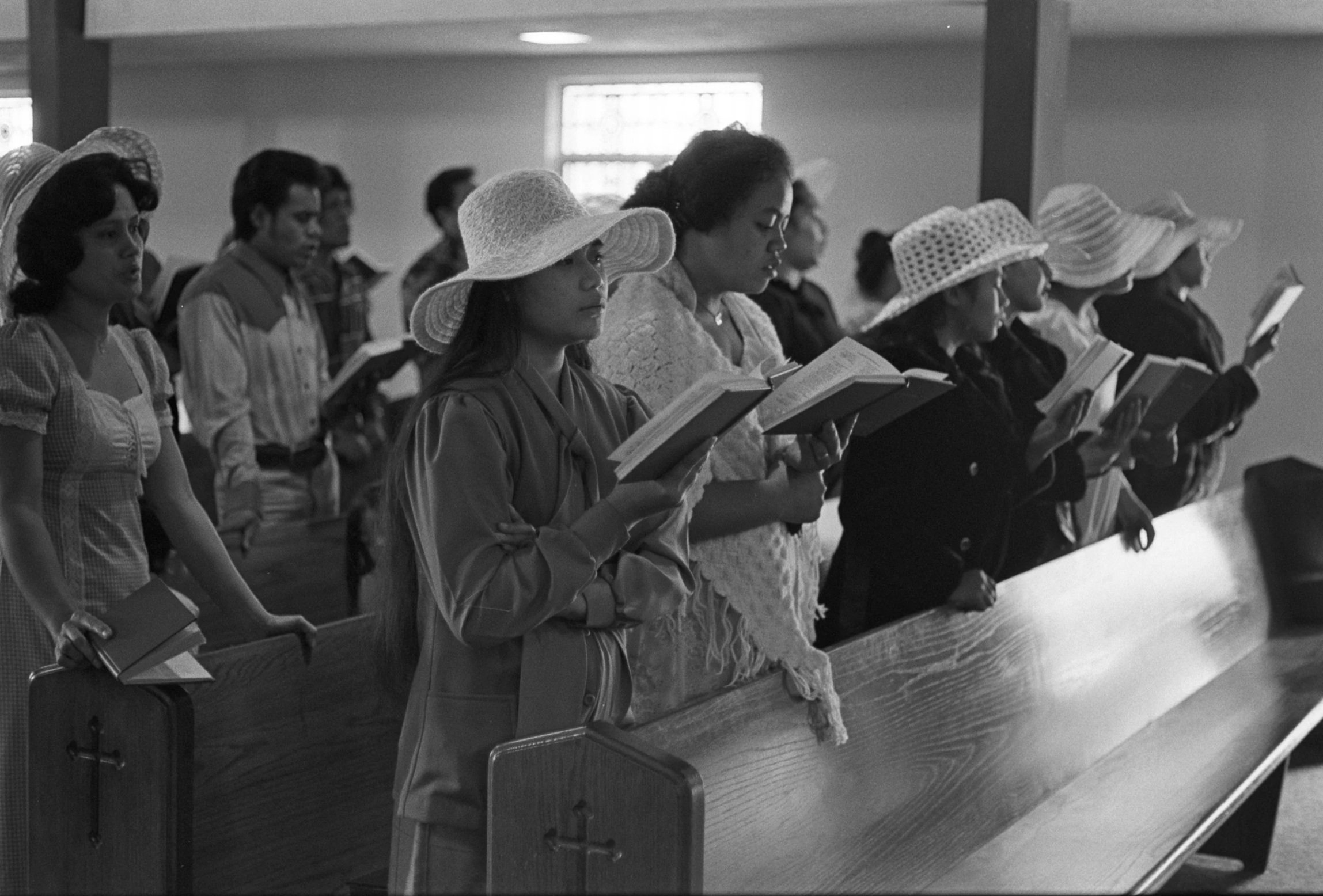 Church Service and Cookout (1972),
Church goers standing in the church's first pew.
Photographed by Visual Communications