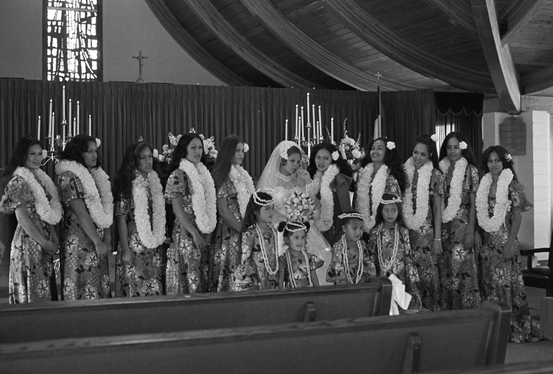Frances & Bill's Wedding Day (1972),
Frances posing at the front of the church with a large group of wedding party members.
Photographed by Visual Communications