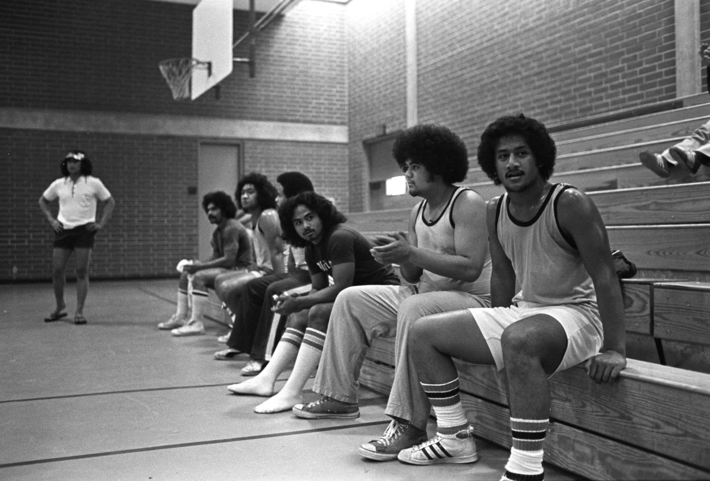 Players Watch From Bleachers (1977-1978),
Players sitting on the bleachers and watching the game.
Photographed by Visual Communications