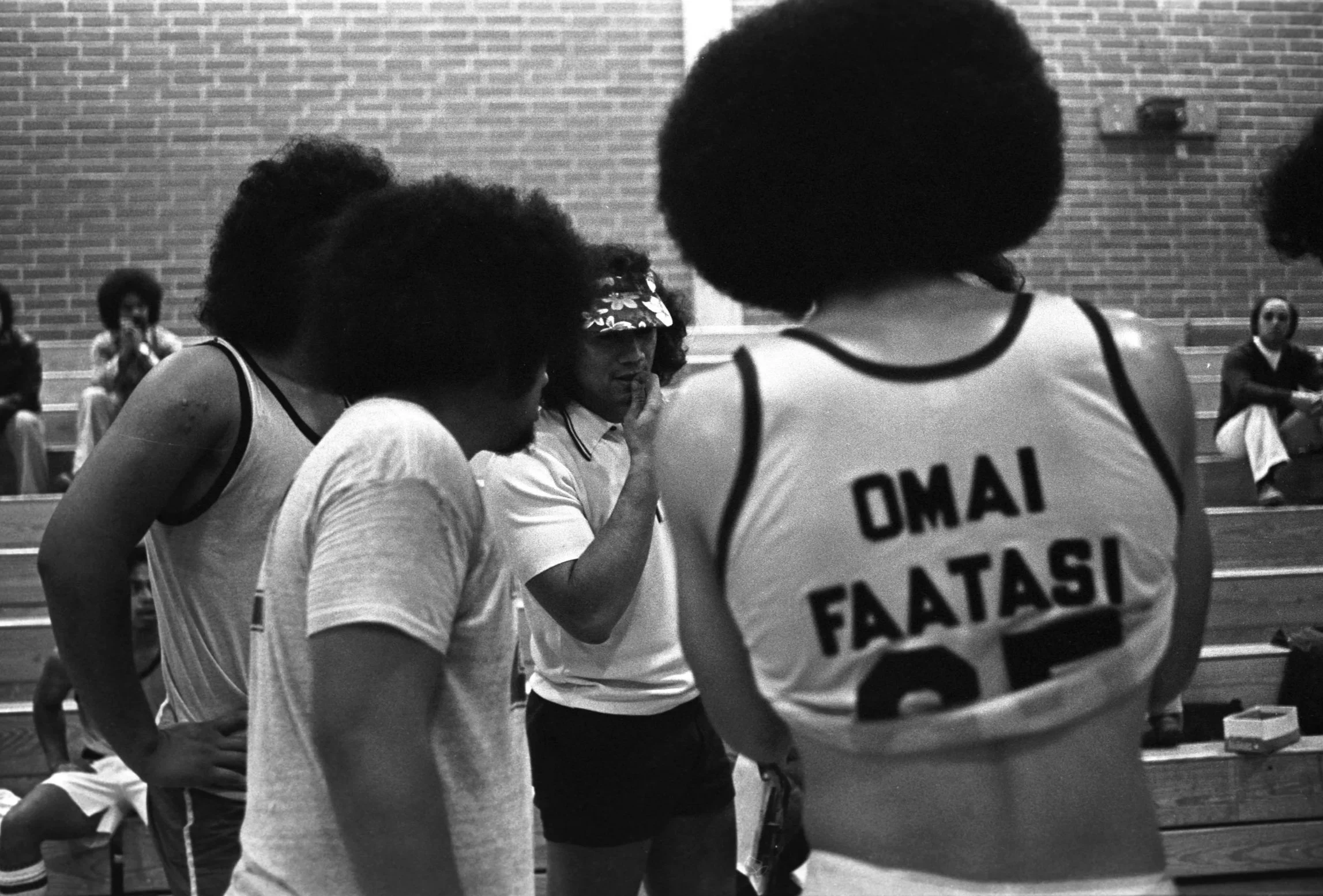 Coach With Players (1977-1978),
A coach with a huddle of players in the Carson High School gym.
Photographed by Visual Communications