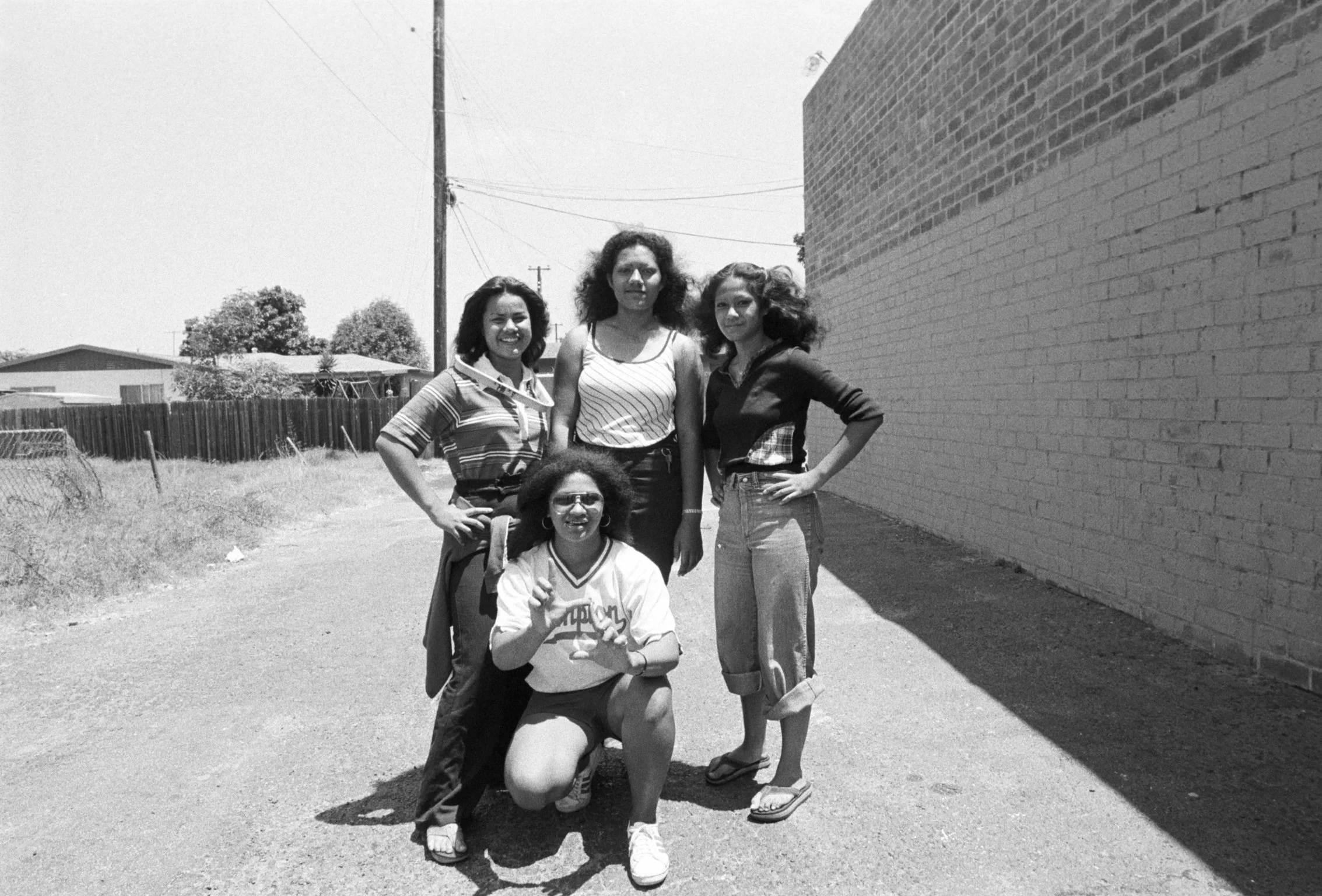 People in Alley Next to Omai Office (1977-1978),
Four people in the alley next to the Omai Headquarters in Carson.
Photographed by Visual Communications