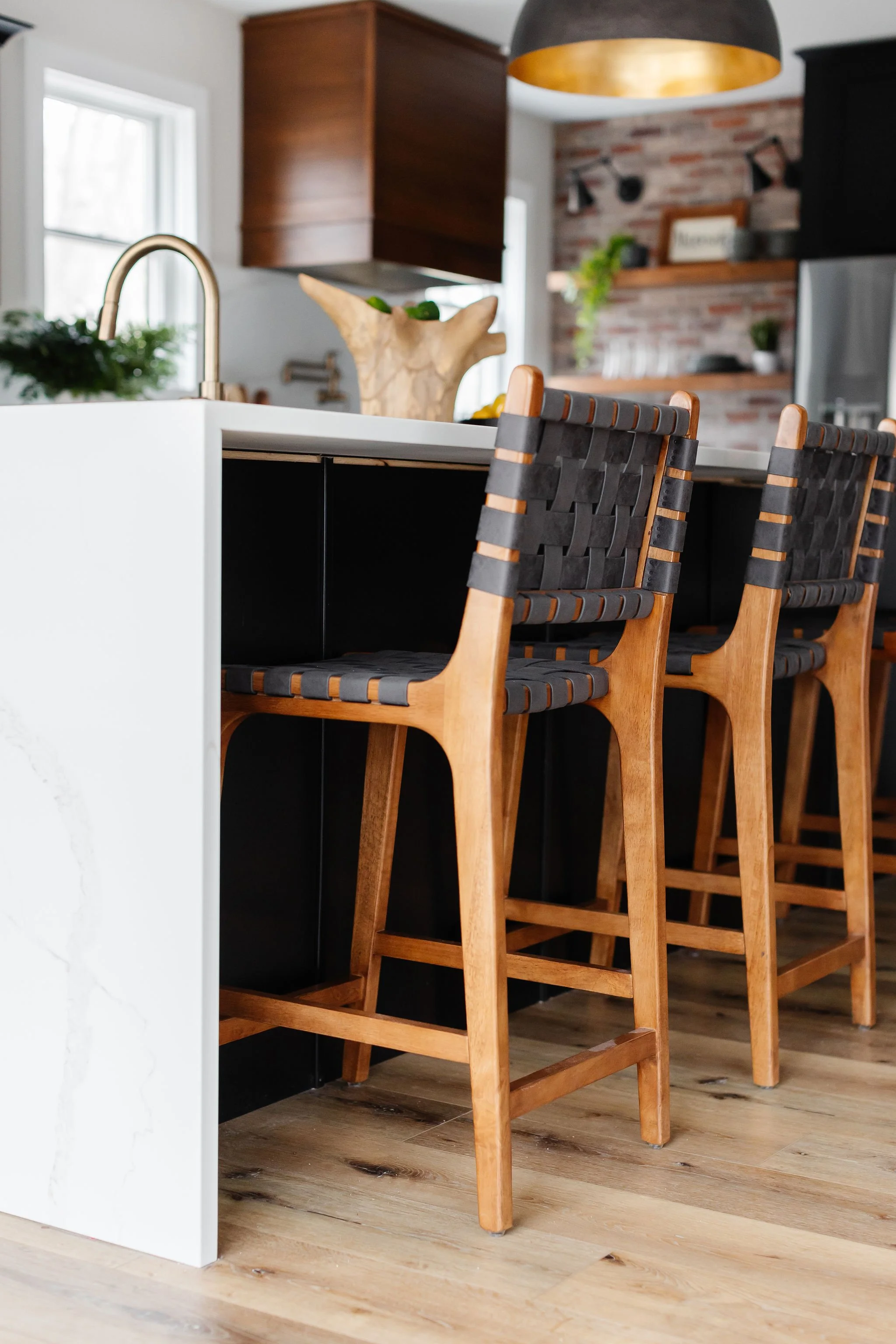 wood and black leather stools 