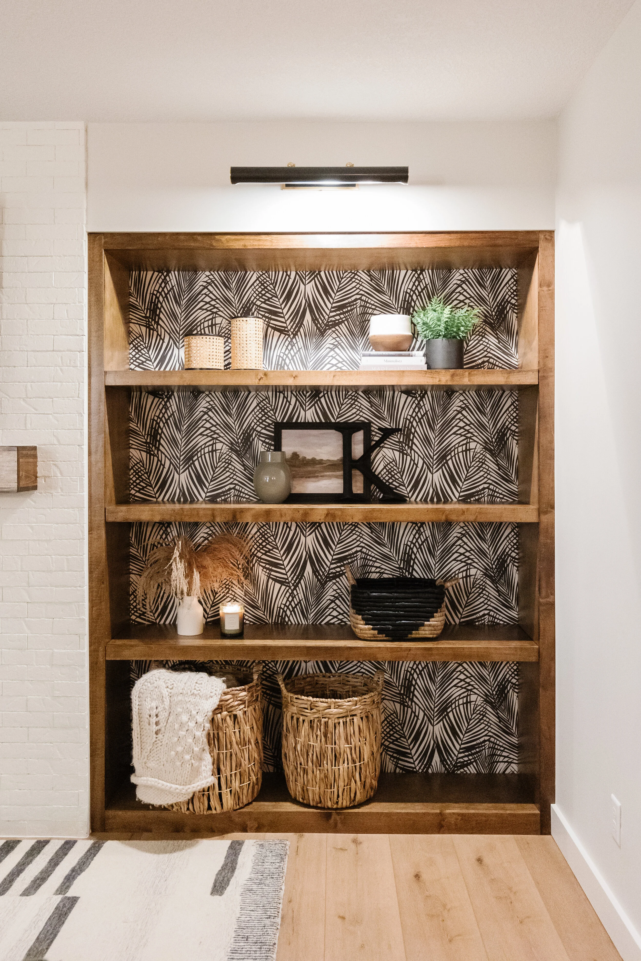 close up of wood built ins with wallpaper accent