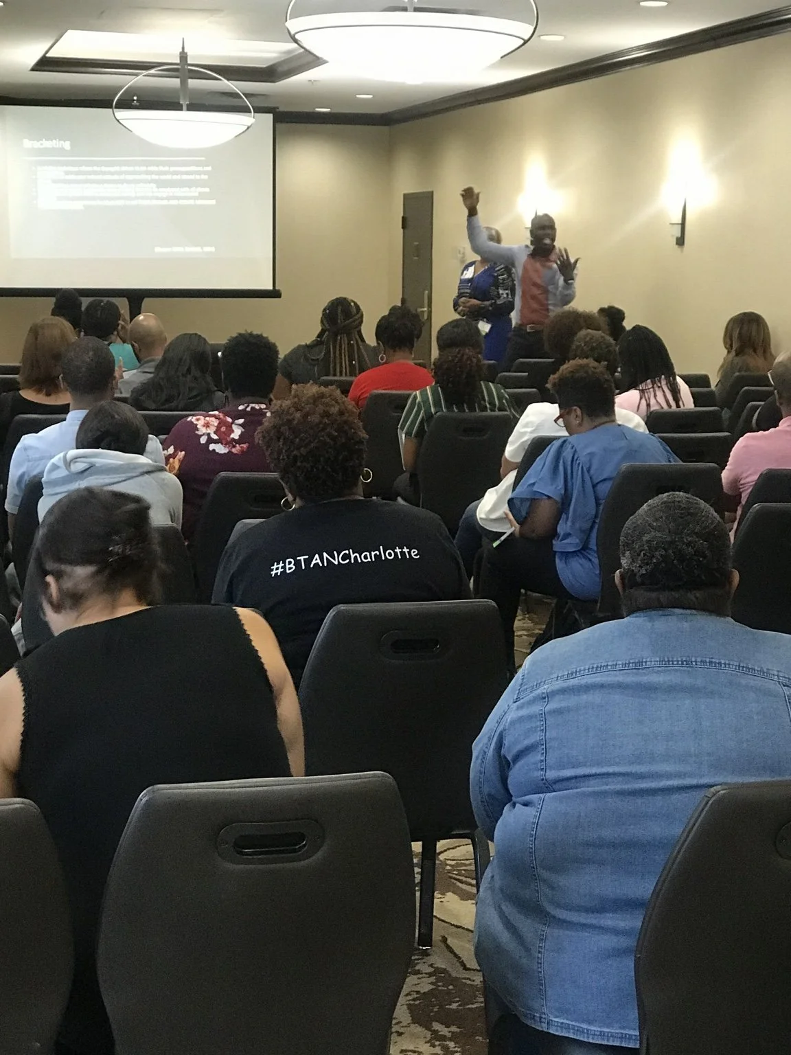 Dr. Dwayne White actively engaging attendees during a training