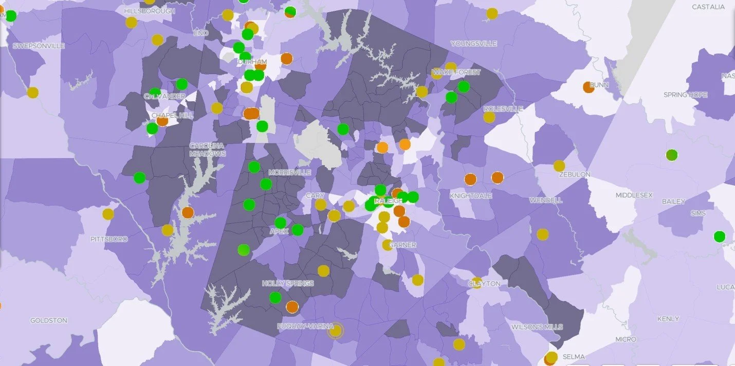 A map showing various regions with colored dots indicating different data points, including green, yellow, and orange dots, along with city names like Raleigh and Cary.
